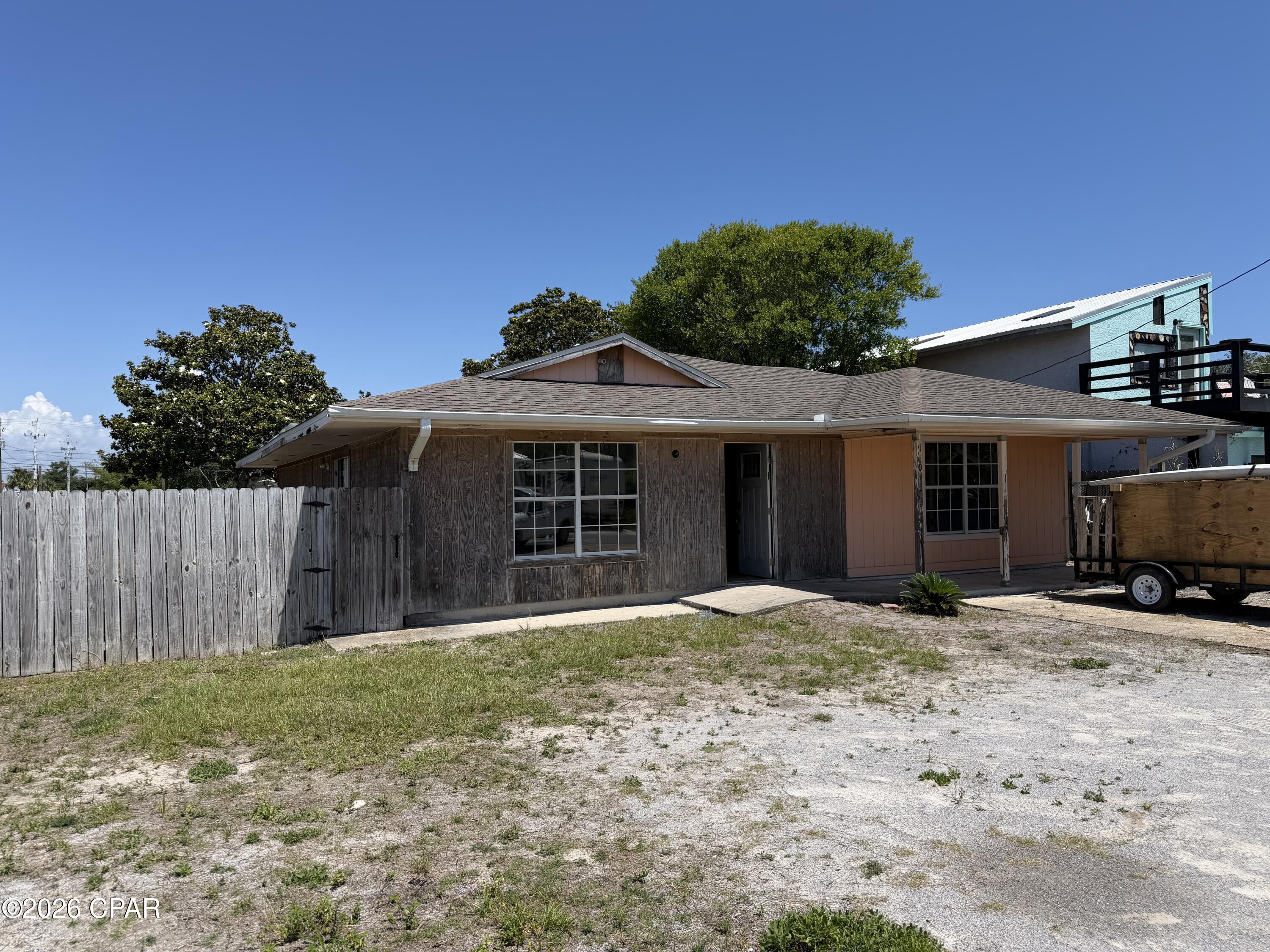 Renovation opportunity for a buyer looking for a full interior rebuild. This single-level home experienced a kitchen fire and is being sold in its current condition. The interior has been opened up in several areas, with exposed framing, ceiling areas, wiring, and unfinished wall sections visible. The floor plan offers a large open main living area, multiple exterior doors, tile flooring in portions of the home, and several rooms with access to the backyard. Bathrooms and interior finishes will need repair, replacement, or completion. Exterior features include a driveway, fenced yard area, and covered entry.

This property is best suited for a buyer, contractor, or investor prepared for fire restoration, permitting, inspections, and renovation work. Seller makes no representation as to condition, systems, permits, or insurability. Buyer to verify all measurements, room count, zoning, repair requirements, and intended use. Cash or renovation financing may be required.