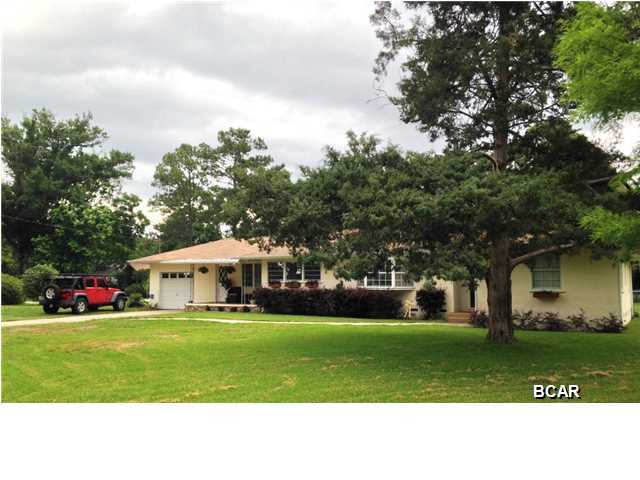 You will appreciate this ADORABLE Lynn Haven home in a quiet location! The house is on a corner lot with 0.51 acres, it has 3 bedrooms, 2 baths, Living room with a beautiful electric fireplace, dining area and spacious family room. All bedrooms have built in closets and all original wood floors throughout the house. Brand new electric water heater just installed (2015). There's a large deck for the family BBQ with a view to the fenced in backyard, so kids and puppies can run free, plus a 24x30 workshop with garage doors. The house has 1 attached garage and a covered front porch off the family room. Call your REALTOR today and schedule a showing! Age, Square Footage, and room sizes approx, if important please verify.