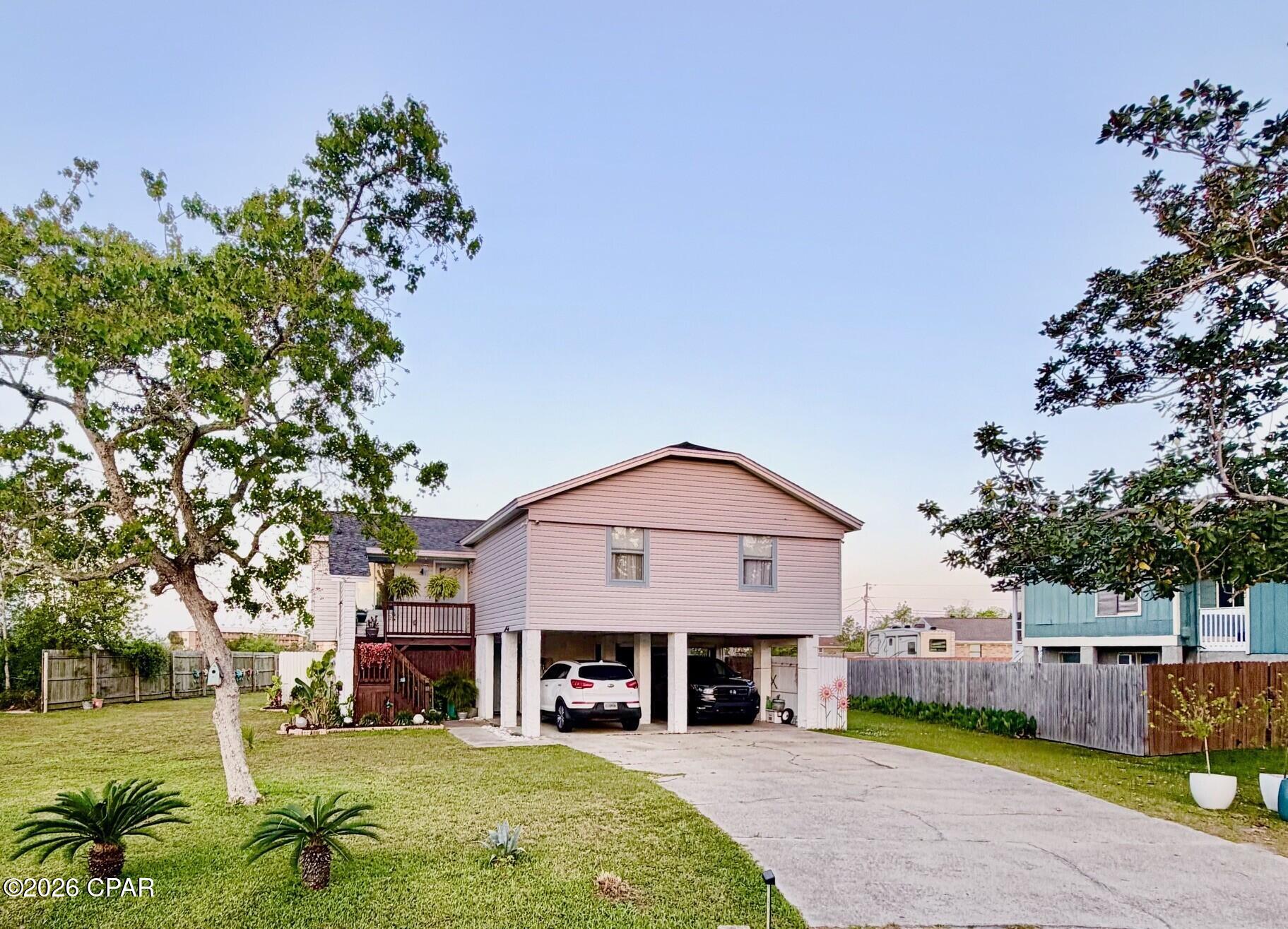 This beautifully maintained home offers stunning views and a prime location just minutes from Tyndall Air Force Base, nestled in the heart of Callaway. Expansive windows throughout the home fill the space with natural light and showcase the serene surroundings.

Enjoy exceptional privacy from the rear of the property which backs up to a canal perfect for kayaking, paddle boarding or fishing from your own dock. The sunsets from the deck are gorgeous and picture worthy.

The main living area features 3 bedrooms, 2 full baths, and a spacious open-concept family and dining area. The kitchen is equipped with granite countertops and stainless-steel appliances, while a large ground-level storage room provides ample space for all your needs. French doors off the living room open to a generous deck, ideal for relaxing or entertaining.

The ground-level efficiency apartment includes a large living space, kitchen, and full bath, perfect for guests, extended family, or potential rental income.

Located in a quiet, peaceful neighborhood near the Bay, this move-in-ready home is a must-see. Schedule your private showing today!

All measurements are approximate and should be verified if important.