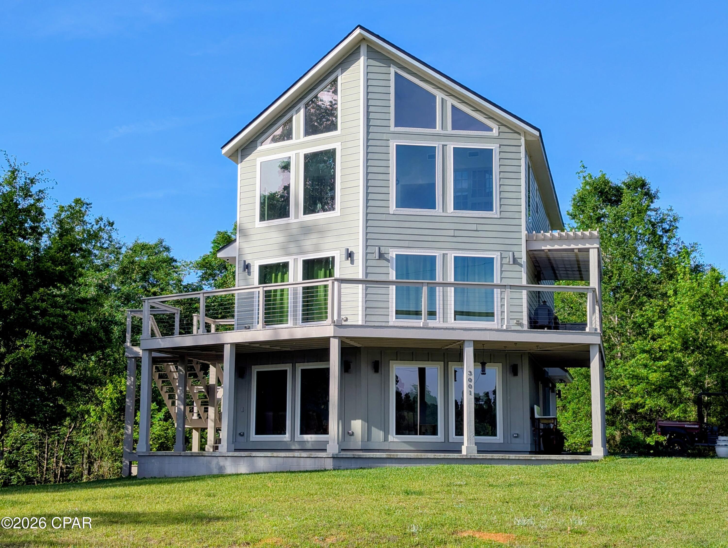 REDUCED -- $10,000. -- REDUCED AGAIN --$20,000--PANORAMIC VIEWS OF MERRITT'S MILL POND + flexible modern living in a 2023 custom build. Situated on a private 1.24 acre lot at the end of a quiet dead-end road. This thoughtfully designed three-story home offers a rare combination of privacy, functionality, and outdoor living.  Inside you will find 4 BEDROOMS, 3 FULL BATHS, and  TWO DEDICATED OFFICES with elevated views  -- ideal for remote work, creative space, or dual home offices.
The first-floor guest suite features a private entrance and a space for future kitchenette ( plumbing and wiring already in place), making for multi-generational living, extended guests, or potential rental use. 
Built for efficiency and comfort, the home includes spray foam insulation,  Low-E windows, and three separate HVAC systems (1 per Level)
The main living area showcases custom cabinetry and woodwork, granite countertop, and an oversize kitchen island designed for both everyday living and entertainment.
Step outside for over 1200 square feet of covered deck and patio space, ideal for relaxing, entertaining, and enjoying the peaceful surroundings.
Located just one mile from the public boat ramp, offering easy access to boating, kayaking, and one of the areas most desirable spring-fed waterways.
This is a RARE opportunity to own a nearly new, move-in ready home with space, flexibility, and views -- without the wait of new construction.
       CLICK ON PHOTO TO SEE MORE.
CALL FOR YOUR APPOINTMENT TODAY -- to see this        Immaculate home !