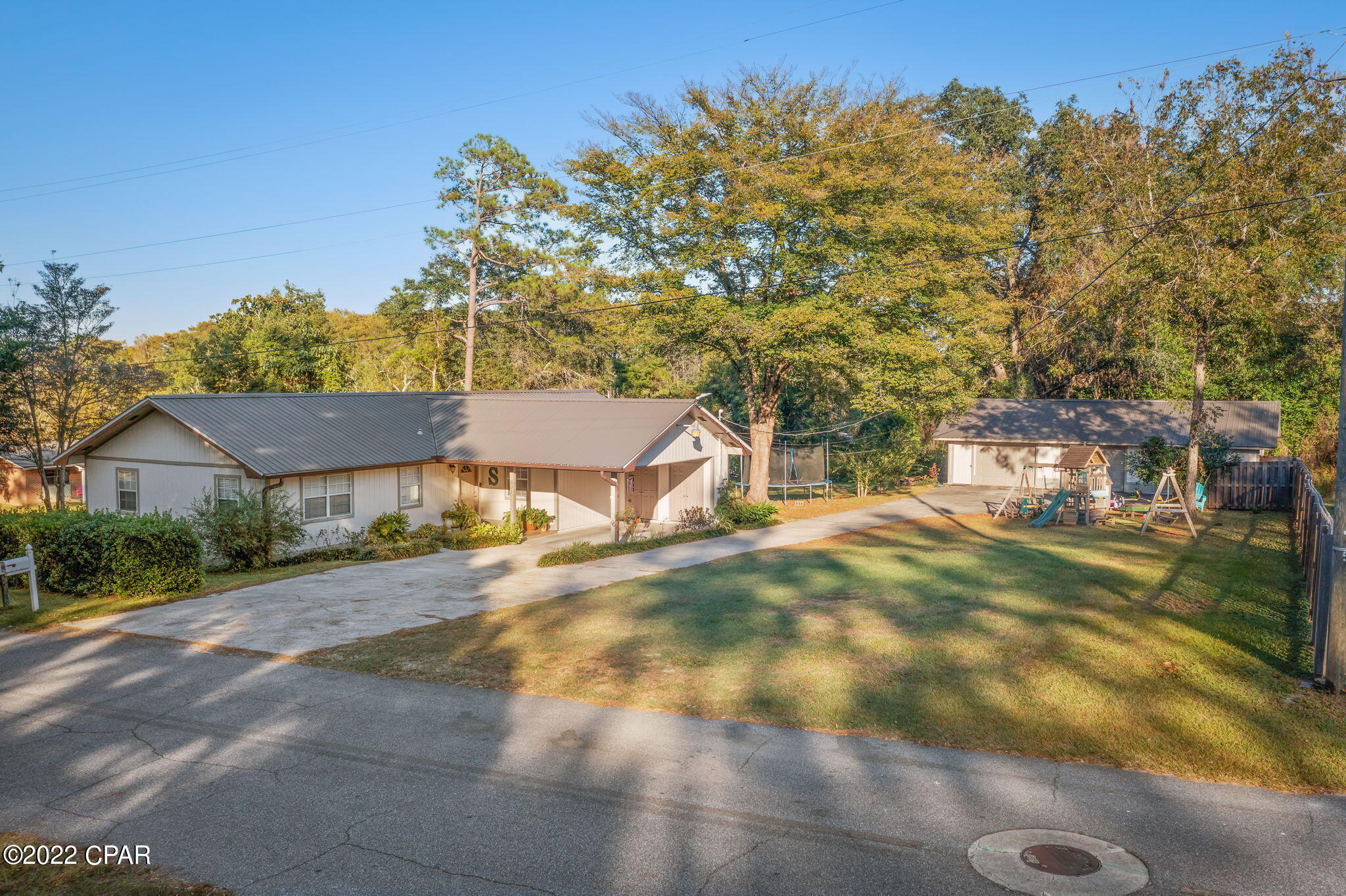 This stunning 3-bedroom, 2 bath home is perfectly situated on a 0.48+/- acre corner lot and is awaiting its new owners! Inside you are greeted with wood look tile, a spacious living room that flows directly into the kitchen/dining area boasting breakfast bar, island, Corian countertops, and an abundance of cabinetry. Other inside features include a 26x12 Florida Room and master bedroom boasting a walk-in closet and attached full bath. Outside you will find an attached carport, metal roof, concrete driveway and a 44x24 barn with 3 roll up doors. Home is located inside the city limits, a short drive to schools, shopping and restaurants.
