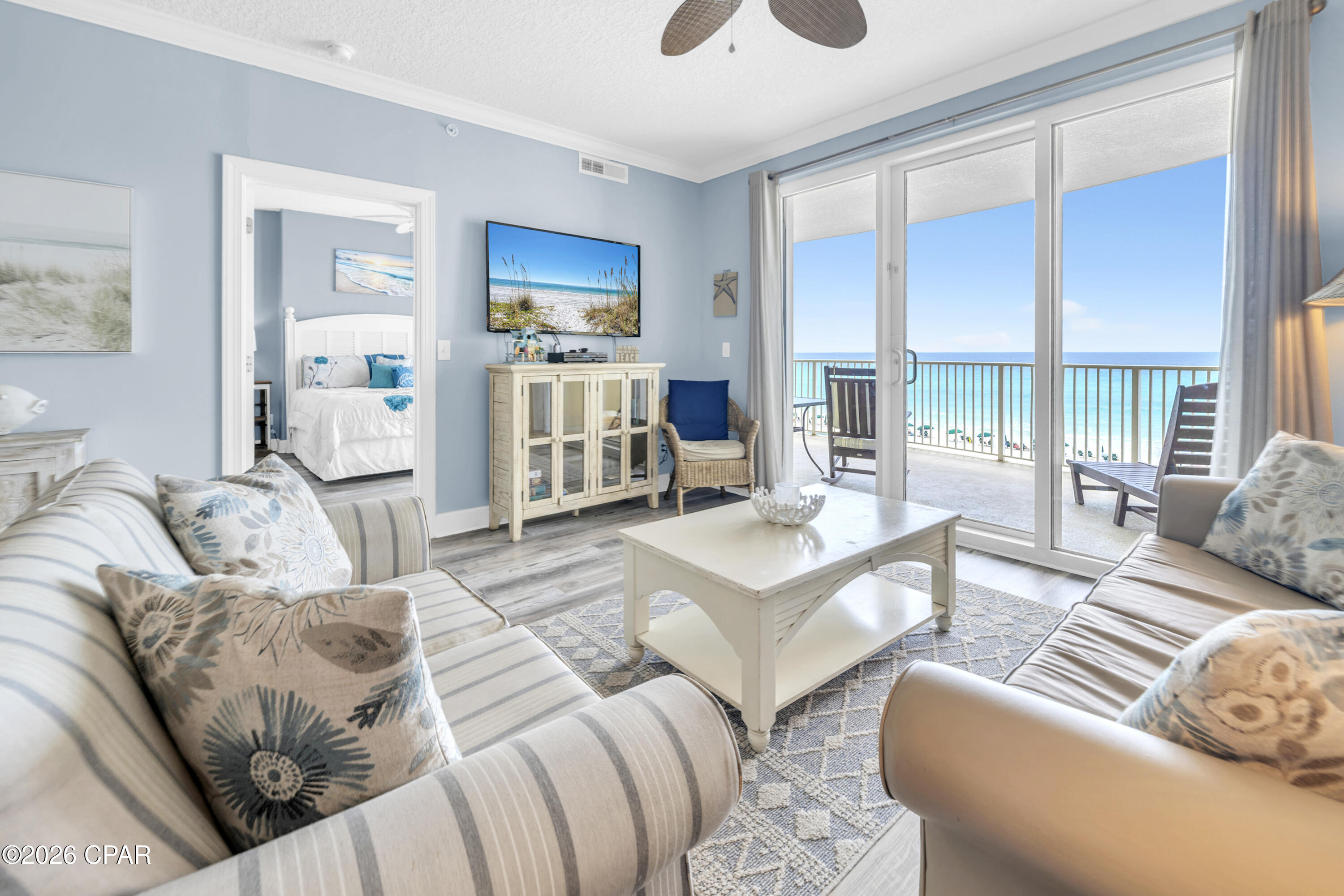 Welcome to Emerald Isle 402, where thoughtful updates, exceptional maintenance, and breathtaking Gulf views come together to create a truly turnkey beachfront retreat. Located on the desirable fourth floor, this spacious Gulf-front residence offers the convenience of a lower-floor location while still delivering stunning panoramic views of the emerald-green waters and sugar-white sands that define Panama City Beach. Designed for both personal enjoyment and strong rental performance, the open-concept floor plan comfortably accommodates up to six guests while maintaining a bright, airy feel throughout. Nine-foot ceilings, crown molding, and expansive sliding glass doors fill the living spaces with natural light and showcase the spectacular Gulf views from nearly every angle. The kitchen, dining, and living areas flow seamlessly together, creating an inviting space for gathering, entertaining, and relaxing after a day on the beach. What truly sets this residence apart is the extensive list of updates already completed. Luxury vinyl plank flooring throughout provides a clean, modern coastal aesthetic while offering exceptional durability for beachfront living. Both bathrooms feature beautifully updated custom walk-in showers, and the property has been meticulously maintained with recent improvements that include new LVP flooring (2025), washer and dryer (2024), HVAC system (2021), and water heater (2019). Offered fully furnished with high-end furnishings and accessories, the condo is truly move-in or rental ready from day one. The Gulf-front primary suite offers direct balcony access and stunning water views, creating a private sanctuary where you can wake up to the sights and sounds of the Gulf each morning. Both bedrooms feature private bathrooms, ensuring comfort and privacy for owners and guests alike. One of the home's standout features is the oversized Gulf-front balcony, measuring approximately 10' x 28'. Its distinctive curved design captures sweeping views of the coastline, providing the perfect setting for morning coffee, afternoon relaxation, or unforgettable sunsets. Accessible from both the living room and primary suite, the balcony serves as a true extension of the living space and embodies the best of coastal living. Additional conveniences include an exterior storage closet and HOA dues that cover most utilities, helping simplify ownership and property management. Emerald Isle owners and guests enjoy an outstanding collection of resort-style amenities, including indoor and outdoor pools, a whirlpool, Gulf-view fitness center, sauna, steam room, BBQ grilling area, and a poolside pavilion. Pet owners will also appreciate that owners are welcome to bring their four-legged family members. Situated on the quieter west end of Panama City Beach, Emerald Isle offers the perfect balance of tranquility and convenience. You're just minutes from Pier Park, popular dining and entertainment venues, shopping, and Northwest Florida Beaches International Airport, while still enjoying the peaceful beachfront setting that continues to make this one of the area's most sought-after destinations. Whether you're searching for a primary residence, second home, or proven investment property, Emerald Isle 402 delivers the rare combination of updated finishes, excellent condition, resort amenities, and Gulf-front living that is increasingly difficult to find. All measurements and information are deemed reliable but should be verified if important.