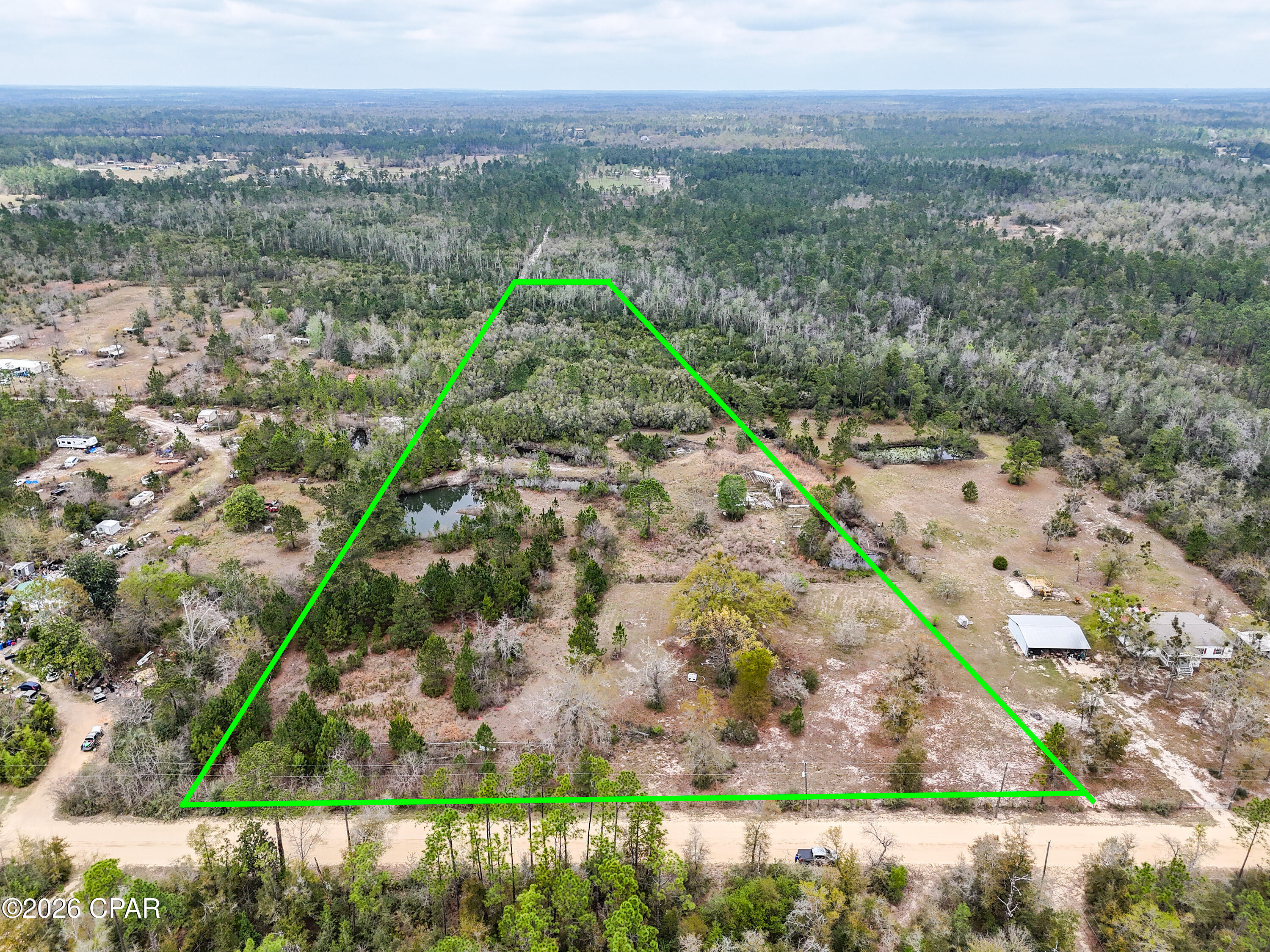 Bring your horses! Build your dream home or place a manufactured home on this 10 acre property. Located 1/4 mile off Highway 231, this property is perfect for anyone needing a little ''elbow room'' or has horses. There are a few small ponds on the property, woods in the back, a power pole, a well, and had a septic system that could be made usable. The property is partially fenced as well. Purchase 12141 Harrington Rd to have 20 acres with a large home (MLS #780703).  Located only 35 minutes from shopping, dining, and the world's most beautiful beaches, this land is priced to sell!
