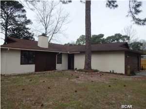 This home is in a great area on the eastern edge of Panama City Beach - close to the Navy base, Grand Lagoon waterfront, marinas, public boat ramps, beaches and St Andrews state park. Plus it's just a few miles to Pier Park and all the shopping and entertainment you could want. The spacious great room has a fireplace and double doors to a patio and huge fenced in backyard. If you are a boating enthusiast, you will have plenty of room to store a boat and trailer in the side yard. The back yard also include an area that contains a pond, that if stocked with fish, could be a delightful respite while sitting on the adjacent bench. Inside the home, are three large bedrooms, a breakfast area with a bar, and large kitchen. The garage accomodates two cars and also offers extra storage space.