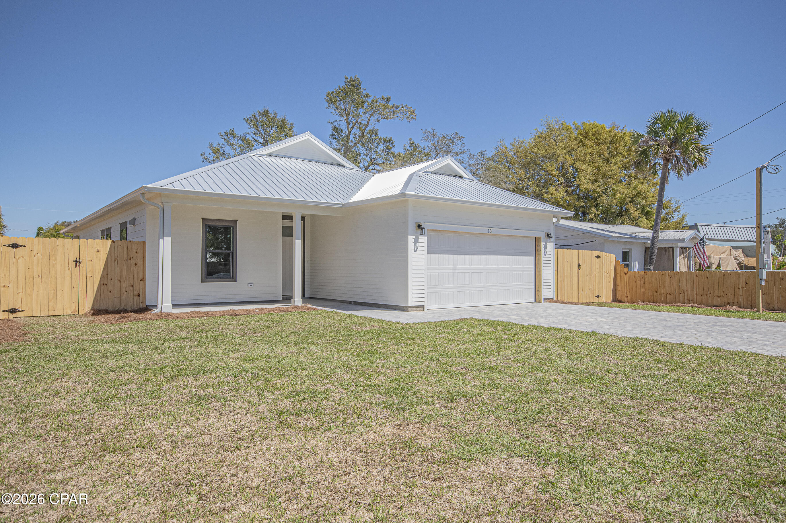 Step into this beautifully designed semi-custom new construction home, thoughtfully upgraded inside and out. From the moment you arrive, you'll notice the curb appeal with durable Hardie siding, a metal roof, and impact-rated windows and doors that may help reduce insurance costs. The exterior is complete with a paver driveway, sodded yard with irrigation, a privacy-fenced backyard, and a spacious cornered patio ideal for relaxing or entertaining.
Inside, the home features an open, modern layout with 9 and 10 foot ceilings, 8 foot doors, and luxury plank vinyl flooring throughout. The kitchen stands out with white shaker cabinets with crown molding, quartz countertops, a large island with built-in microwave, gas range with a vented stainless hood, full-size refrigerator with water and ice in the door, dishwasher, and garbage disposal.
The living area is warm and inviting with a tray ceiling, recessed lighting, upgraded fixtures, and an electric fireplace. The primary suite continues the elevated feel with its own tray ceiling, fan, and recessed lighting. The en-suite bath offers a double vanity with quartz countertops and a spacious 4 by 5 tiled shower with a built-in bench.
Additional features include wood shelving in all closets and pantry, spray foam insulation in both the walls and attic for energy efficiency, and a gas tankless water heater for endless hot water.
Conveniently located just minutes from Tyndall Air Force Base, Bay Oaks Park, and nearby shopping, this home offers both comfort and convenience.