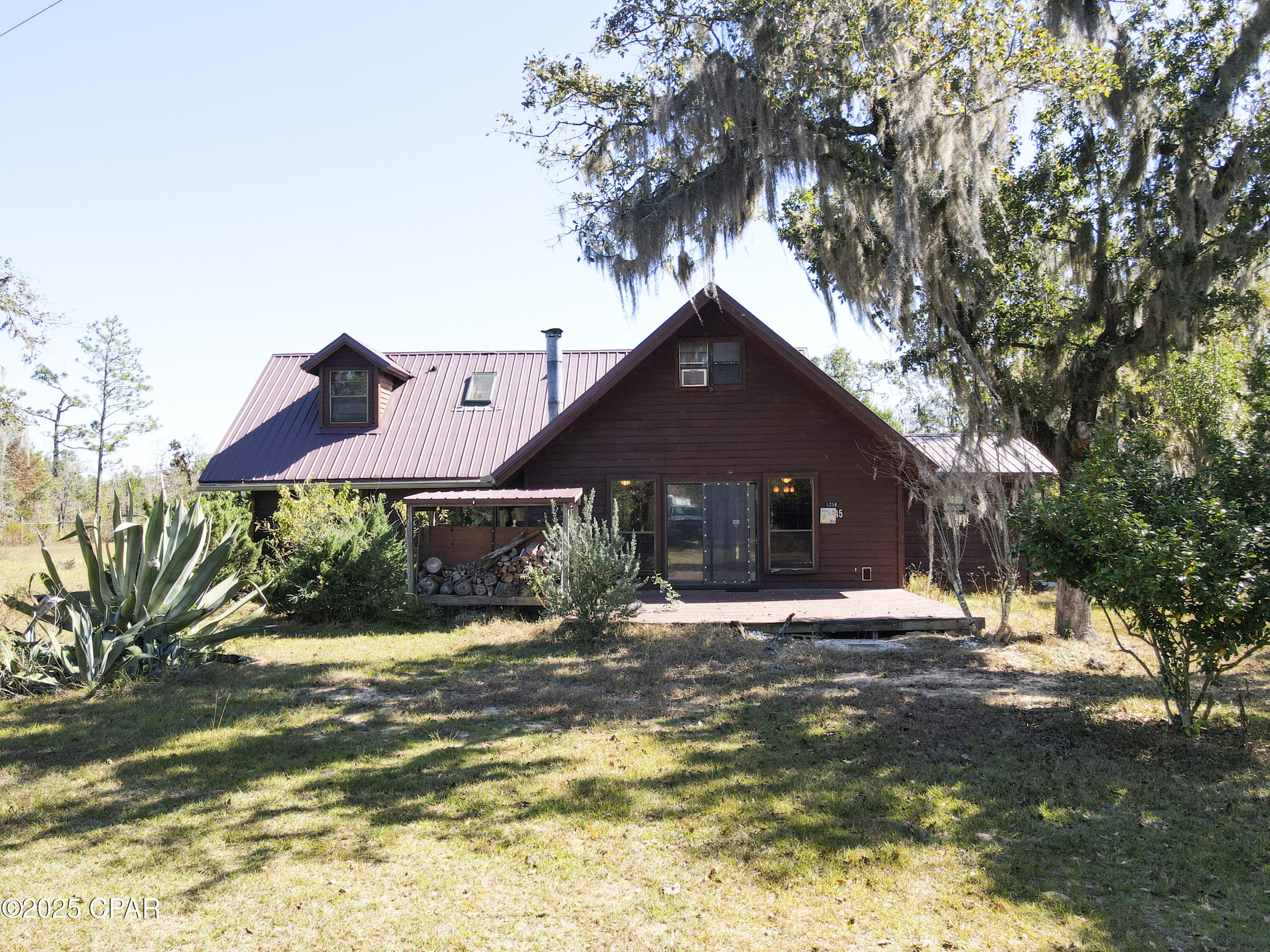 This four-acre oasis is hidden 'round Willow Bend in the heart of Calhoun County, Florida and generously offers 5 bedrooms and 2 bathrooms.  The two-story cabin style home embraces its wooded surroundings as it is completely dressed in western red cedar from Washington State both inside and out.  Ample outdoor space invites you to outdoor showering after yard work and leisure time enjoying nature on one of the home's porches/decks.  Three out buildings promise to accommodate hobbies and equipment.  The most impressive of which is a 32 x 70 red iron barn on a concrete foundation with power and three roll up doors.  This property keeps your options wide open... live a quiet and simple life or add some livestock and plant a garden to try your hand at homesteading.   No need to wait.  Book a showing before this spot is claimed by someone else!