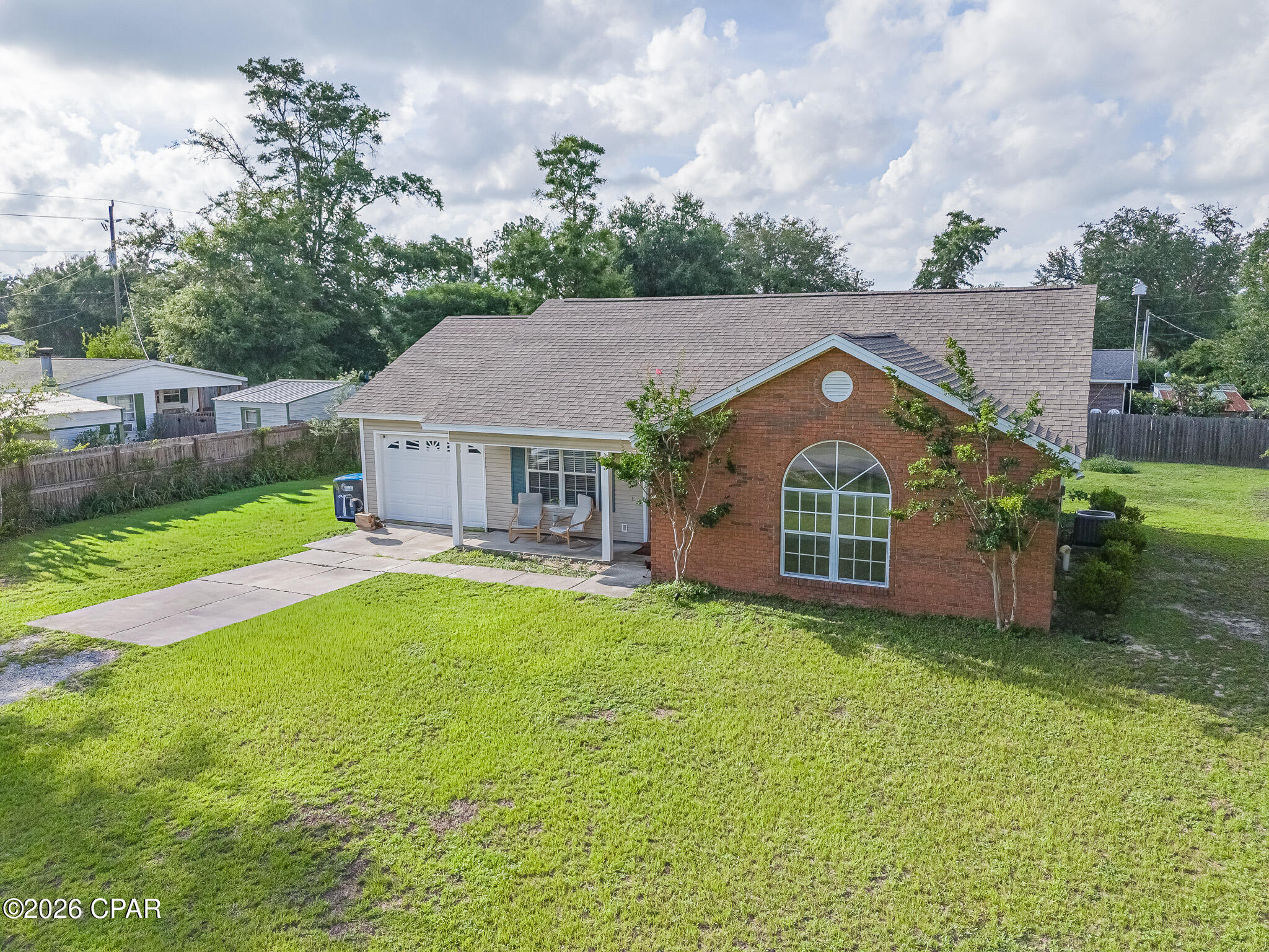 Enjoy the countryside of Panama City in the Free State of Florida! This delightful 3 bedroom 2 bathroom home sits on a spacious lot, ready for its next owner. From the inviting front porch, ideal for sipping your morning coffee, to the bright and welcoming interior filled with natural light, every corner is welcoming. The open kitchen and dining area flow effortlessly, making daily life and entertaining a breeze. Outside, the expansive backyard offers plenty of room for pets, gardening, or boat storage. With nearby boat ramps, you're minutes from salt and freshwater adventures. Conveniently located just 15 miles to NW Florida International Airport, 22 miles to the white sandy beaches, and just a short drive to ''town'' with easy access to schools, shopping, and dining, this gem is powered by Gulf Coast Electric Co-op, not FPL and is ready to welcome you home!