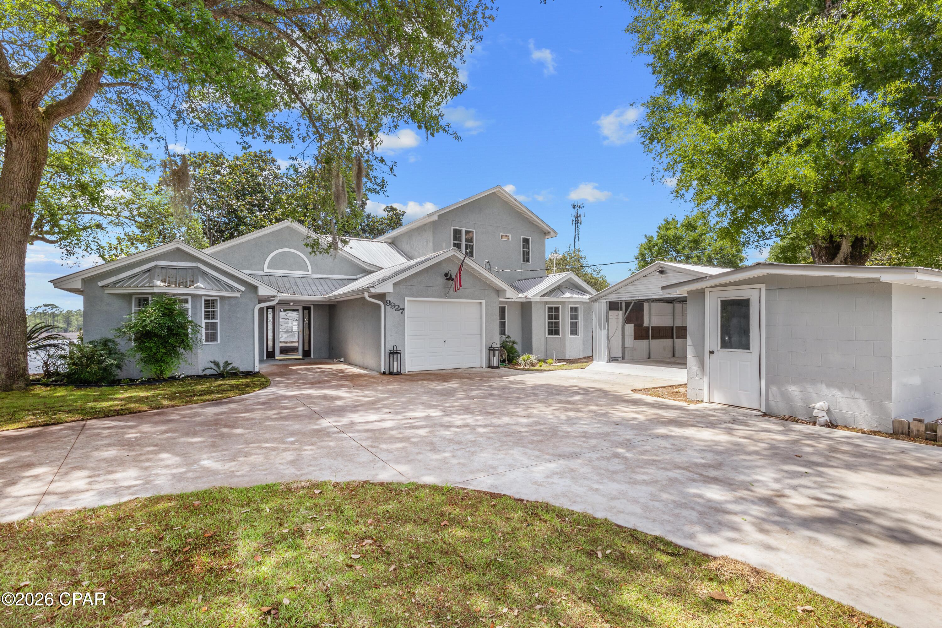 WATERFRONT on Burnt Mill Creek with direct Gulf access and no HOA! This unique property also includes a separate income-producing 1 bedroom, 1 bathroom cottage with a current tenant already in place.

If you've been dreaming of waterfront living, this is your chance to own a private slice of paradise. Launch your boat from your backyard, take a trip to Shell Island, fish from your dock, or spend the day kayaking, paddleboarding, or jet skiing right from home.

One of the most special features of this property is the privacy. Surrounded by conservation land, the natural beauty and peaceful setting are protected, meaning you won't have to worry about future subdivisions or dense development changing the landscape around you.

The wildlife here is something truly special. It's common to spot dolphins swimming through the creek, pelicans diving for fish, and even the occasional otter or manatee passing by your dock. Between the peaceful water views, mature Magnolia trees, and protected surroundings, this property offers the kind of Old Florida atmosphere that's becoming harder to find.

This spacious home offers stunning water views from nearly every room. The large living area features double French doors that open into a Florida room overlooking the creek. The kitchen is beautifully appointed with granite countertops, custom cabinetry, a breakfast bar, and a large pantry.

The oversized laundry room includes built-in cabinetry and a bay window, making it ideal for a home office, hobby space, or extra storage. Just off the kitchen and dining area, the screened porch creates the perfect setting for relaxing evenings and sunset views over the water.

Designed for both comfort and functionality, the home features generous storage throughout with multiple large closets and built-in storage areas rarely found in waterfront properties.

Upstairs, the primary suite features French doors leading to a private screened balcony with breathtaking waterfront views. A second master suite downstairs includes a double vanity, walk-in closet, and French doors opening to the Florida room. The additional downstairs bedroom is generously sized and features a charming bay window.

Outside, the property is designed for enjoying life on the water. Large shaded decks sit beneath beautiful mature Magnolia trees, creating a peaceful outdoor retreat even during the hottest summer days. Two docks provide ample space for boats, kayaks, and jet skis. The covered dock features a motorized boat lift and previously accommodated a 22' bay boat with ease. A fish-cleaning station with water and power makes it easy to clean the day's catch right from your dock. 

Fishing enthusiasts will love the location. Head up the creek for bass and bream, or venture into the bay for redfish and trout. Burnt Mill Creek is especially known for excellent speckled trout fishing during the winter months.

Additional features include:

25' x 20' Carolina carport built in 2024
Two storage sheds
Short-term rentals allowed
3,667 SF total area with room for multiple families or guests
Conveniently located:

7 minutes to Northwest Florida Beaches International Airport
15 minutes to the beach
15 minutes to Lynn Haven shopping and dining
25 minutes to 30A
30 minutes to historic downtown Panama City
Whether you're searching for a waterfront forever home, vacation property, or investment opportunity, this one offers the best of Florida living with income potential already in place.

All measurements are approximate and should be verified if important.