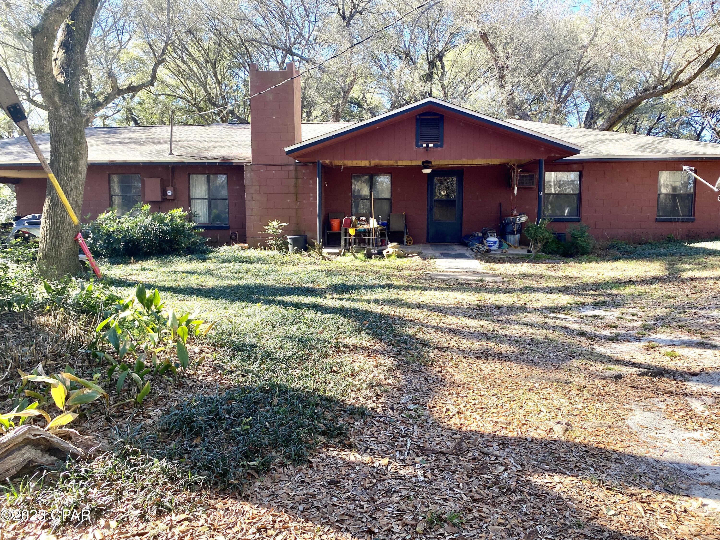 HOME, BARN, POND, 46 ACRES, PRIVATE DRIVE! 4 bedroom/2 bath block home fixer-upper on 46 acres of prime land which encompasses a mix of hardwoods, pasture, and a small pond. A long private winding drive leads to the home which is set within a cloak of bountiful mature live oaks.  Home has open concept kitchen, living, and dining area with a brick fireplace. Some cypress wall siding has been installed in parts of the house.  Some renovations had begun in the master bedroom/bathroom, but will be left for buyer to complete with their own custom designs. There is a 55 by 45 pole barn on the premises. Adjoining parcel of 100 acres also for sale if desired! House is in need of repairs/renovations so cash or conventional only.