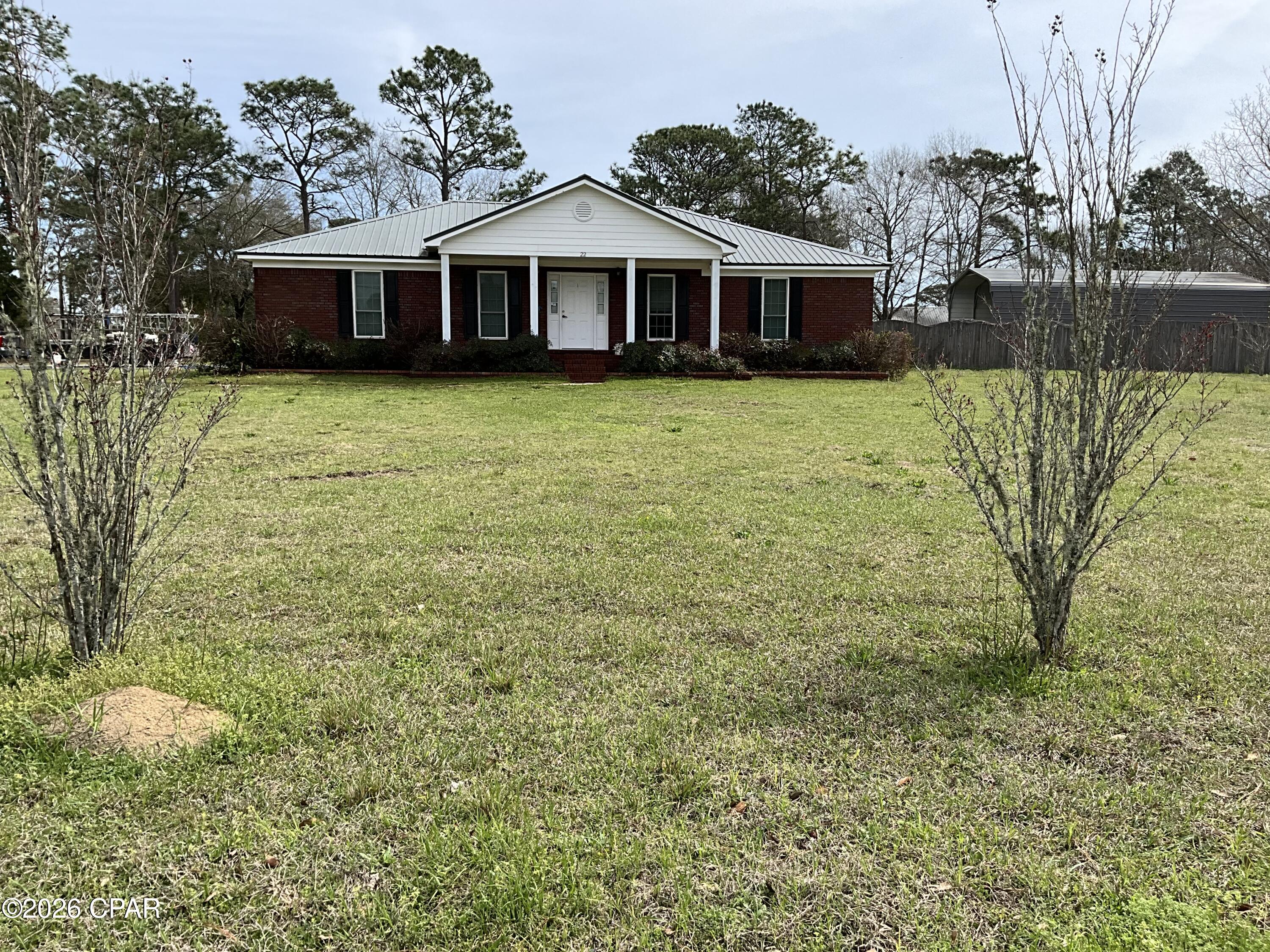 PRICE ADJUSTMENT, MOTIVATED SELLER. BRING ALL OFFERS. Lovely brick home on large corner lot a little over an acre. Total under roof 2889 square feet with 1848 square feet heated and cooled. Three bedrooms split floor plan and two full baths. Master bath has 2 walk-in closets, double vanity and a separate shower. The additional bedroooms have walk-in closets. Hardwood and LPV throughout the home. Spacious two car garage with loads of extra parking. The Fenced (privacy fence) backyard has a 20 x 40 covered RV parking space and an additional 18 x 20 carport space. Carport space has an enclosed 12 x 18 workshop on the back. Entrance to the back yard is a double gate to allow for large RV . The home had solar panels installed in 2022 with an Tesla whole home backup battery. A new AO Smith Voltex 60 gallon commercial grade water heater installed 2025. No mandatory HOA, there are several lakes in the subdivision that require a $100 a year fee for access/ use. No gas powered motors on the lakes.