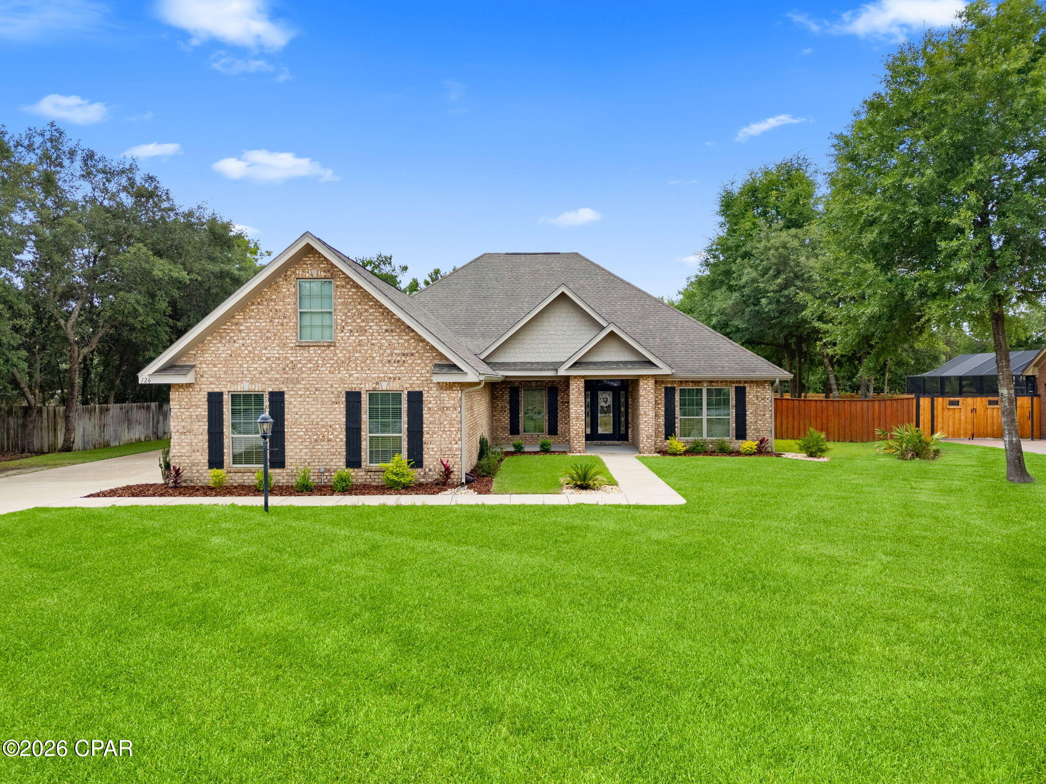 Welcome to this stunning custom-built home located in the highly sought-after gated community of Lake Merial, where oversized homesites, peaceful surroundings, and natural beauty create the perfect blend of privacy and convenience. Enjoy a quiet, tucked-away setting while remaining just a short drive from shopping, dining, and the white sandy beaches of the Gulf Coast. Residents of Lake Merial also enjoy private access to the lake for kayaking, paddleboarding, fishing, or simply unwinding by the water.

Situated on a spacious lot, this beautifully maintained craftsman-style home offers an exceptional layout designed for both everyday living and entertaining. The backyard is truly a showstopper featuring a stunning custom pool surrounded by gorgeous landscaping, creating your own private resort-style retreat. Whether you are hosting summer gatherings, enjoying evenings under the screened-in patio, or watching the kids play in the expansive fenced backyard, this outdoor space was made to be enjoyed. A double gate provides added convenience for boat or recreational vehicle storage.

Inside, the home features five generously sized bedrooms along with two versatile flex spaces perfect for a home office, playroom, media room, gym, or guest retreat. The open-concept floorplan offers warm hardwood flooring throughout the main living areas, comfortable bedroom spaces, and an abundance of natural light. The kitchen is beautifully appointed with granite countertops, stainless steel appliances, ample cabinetry, and plenty of prep space for entertaining and family gatherings.

The spacious primary suite serves as a relaxing escape with a luxurious ensuite bathroom featuring a soaking tub, separate walk-in shower, and oversized walk-in closet. Upstairs above the spacious three-car garage, you'll find additional flex space ideal for a private bonus room, guest retreat, or multi-generational living setup. The oversized garage itself offers plenty of room for vehicles, golf carts, storage, or workshop space.

From the incredible outdoor oasis to the thoughtfully designed interior, this home offers the perfect combination of comfort, style, and functionality in one of the area's most desirable gated communities.