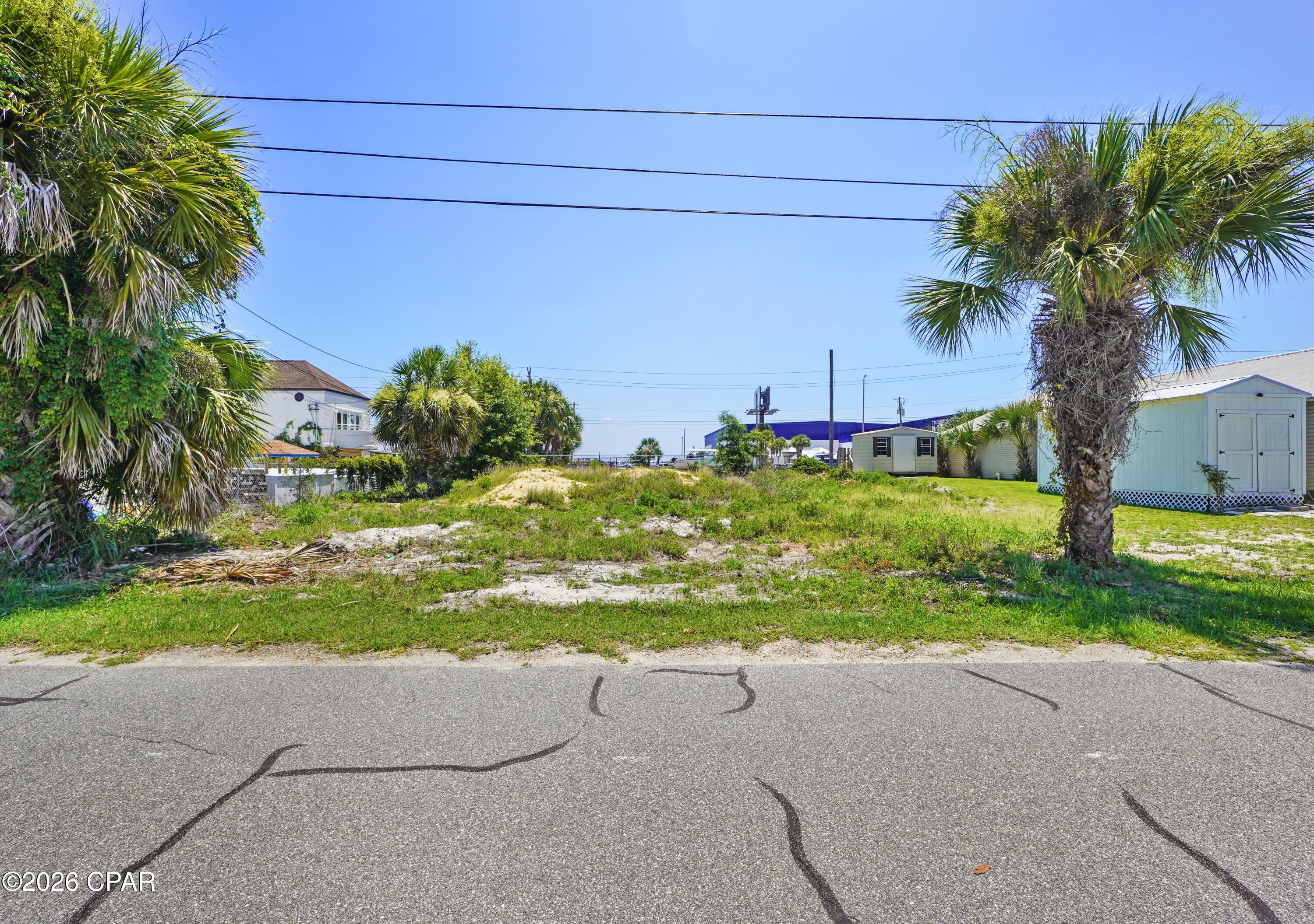 This fantastic blank slate is situated in the desirable Treasure Island area of Panama City Beach, just under half a mile from two public beach access points. Convenient location, convenient access 1 block off Thomas Dr, and views of South Lagoon from your potential home! Enjoy easy access to the pristine white sandy beaches and the sparkling waters of the Gulf. Measuring 75 by 85 feet, this lot provides ample room to design and build your custom dream home, vacation home, or even a short term rental. Conveniently located across from Treasure Island Marina and a public boat launch on Grand Lagoon, it's perfect for boating enthusiasts. Within minutes, you can reach popular spots like Schooners and other top-rated restaurants, St. Andrews State Park, and a variety of shopping destinations! Lot dimensions and important information must be verified by the buyer if important