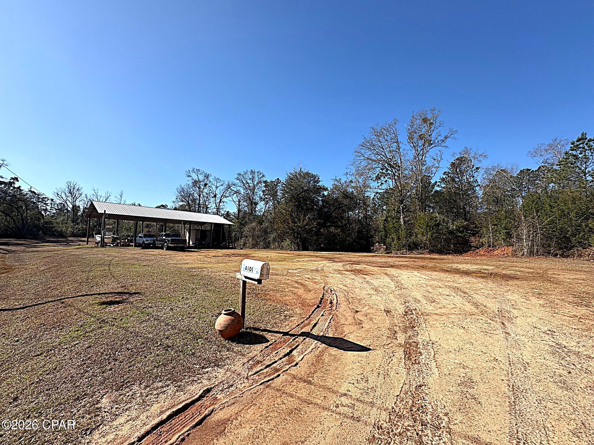 Great building lot that already has a 36 x 60 POLE BARN with electricity, lighting and packed down limerock base. The lot is .70 ACRE and at the end of the private road joining woods and offering privacy. the lot is 101.29 x 299.38 x 101.43 x 298.98 and has a flat level spot perfect for your new home. Well and Septic needed. Deed restrictions do show a minimum of 1350 square foot of living area and  site built home.