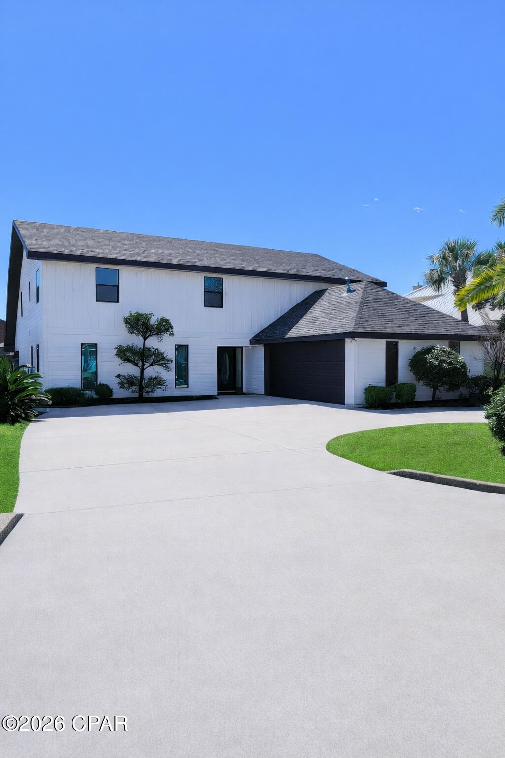 Spacious canal-front home offering 4,432 sq ft in one of Lynn Haven's most desirable areas. This 5-bedroom residence features two primary suites and a well-designed layout that provides both flexibility and generous living space.

Interior highlights include luxury vinyl plank flooring downstairs, bamboo and tile flooring upstairs, stainless steel appliances, quartz countertops, quartz vanity tops, and tile showers throughout.

A true standout is the impressive 850 sq ft bonus room with an indoor putting green, ideal for a media room, game room, or entertaining space.

Step outside to enjoy waterfront living at its best with a boat lift and two jet ski lifts in the boathouse, offering direct bay and Gulf access. A circular driveway enhances curb appeal and provides ample parking.

Large waterfront homes with this size, features, and water access in Lynn Haven are rare — schedule your private showing today.