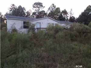 1800 square foot 2004 model, Three bedroom two bathroom Manufactured house with a 1974 two bedroom, one bathroom single wide both needing some TLC on an acre lot offered as is. All sizes approximate please verify accordingly.