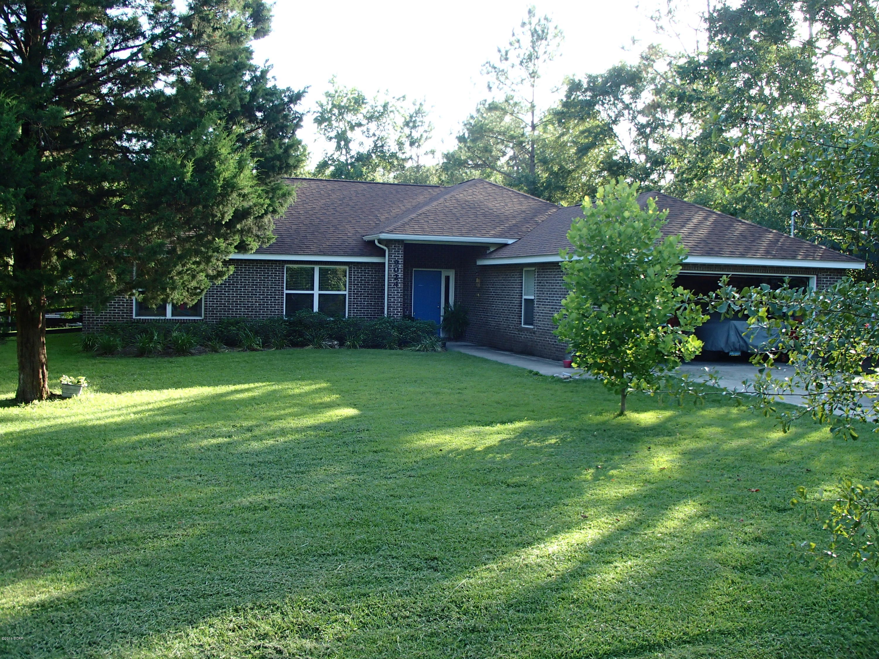 Beautiful all brick home on large 3/4 acre lot overlooking Bear Creek. Home has 4 bedrooms, 2 full baths with split open floor plan. The large living room has vaulted ceiling and wood burning fireplace. Kitchen features oak cabinets, gas stove and large dining area. Master has two large walk-in closets, double vanities and extra-large shower.  Home is on septic tank, water well with water filter system (No water bill or sewage bill). Extra-large attached two car garage has side door and fits two crew cab trucks. At the back edge of property is the clear running creek where you can swim or fish. Best of both worlds; home is NOT in flood zone. 8’x12’ shed stays with the home. Home is located on a loop with no outlet (no traffic). Convenient to Tyndall AFB and NSA Panama City and beaches.