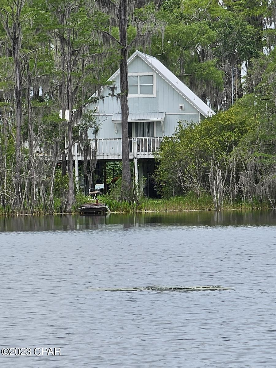 Move-in ready and recent updates, this 3-bedroom, 2-bath home is nestled on 11 private acres at the end of a dead-end road in a gated community, offering the perfect blend of privacy and convenience. Ideally located between two lakes, this property is perfect for those who enjoy fishing, boating, and the outdoors. The home features a functional floor plan, comfortable living spaces, and recent updates throughout. The expansive acreage provides endless opportunities for recreation, gardening, animals, or adding a workshop or additional outdoor living space. Residents enjoy access to community amenities, including boat ramps for easy lake access. Best of all, there are no HOA fees. Whether you're searching for a full-time residence, vacation home, or private retreat, this unique property offers the space, location, and lifestyle you've been looking for. (more photos coming soon)
