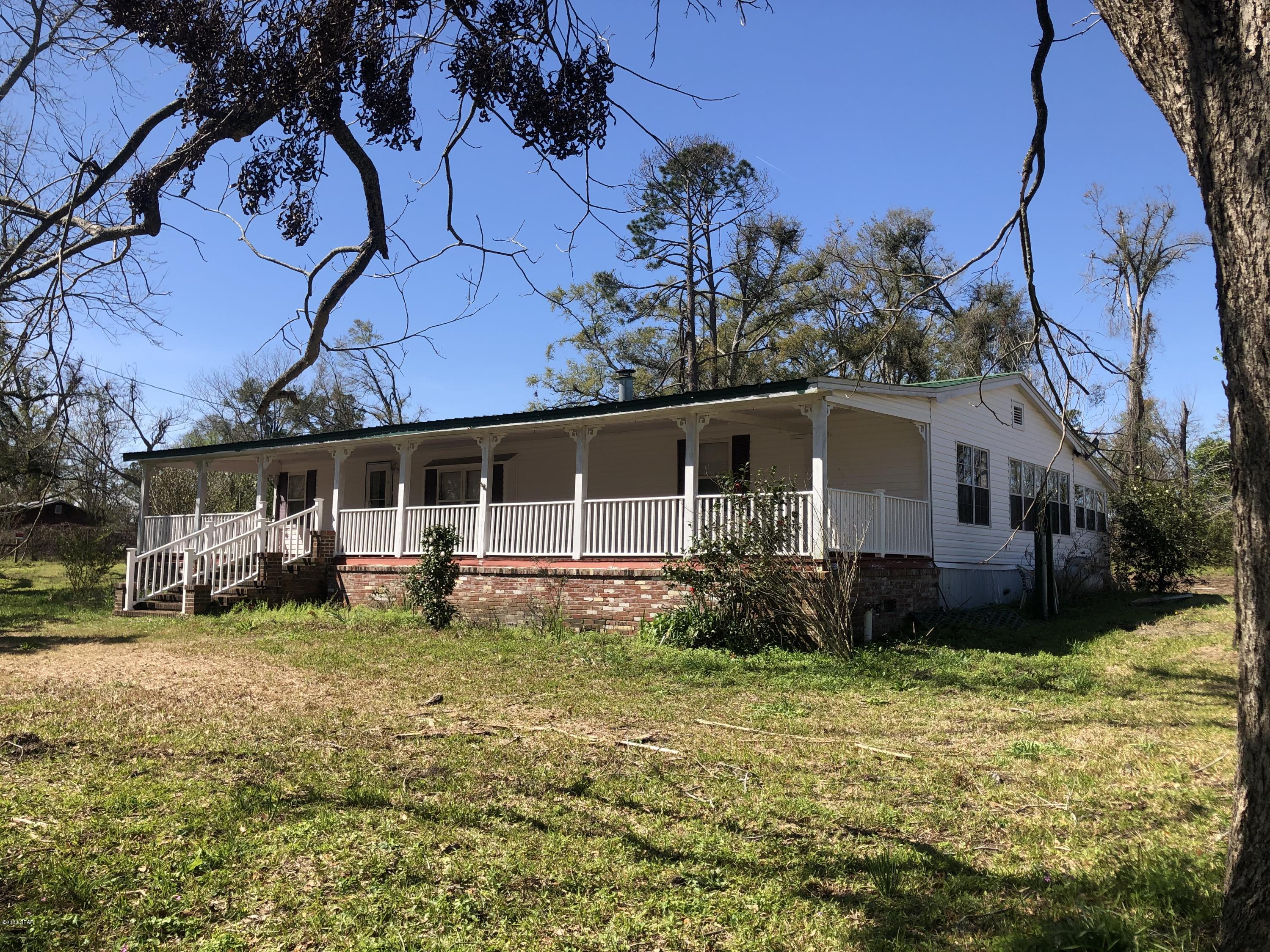 CURRENTLY UNDER CONTRACT, SELLER ACCEPTING BACKUP OFFERS.  Small town living is inviting you to this 3/2 M/H with added space and could be a 4/2 in Greenwood.  Split bedroom design with metal roof and large sweet tea front porch.  All you need is a swing.  Home has a detached 3 car carport with additional room for your boat or lawn mower.  Sits on a half acre lot with nice yard. Come see this home today.  Seller will allow a 2000 painting allowance.