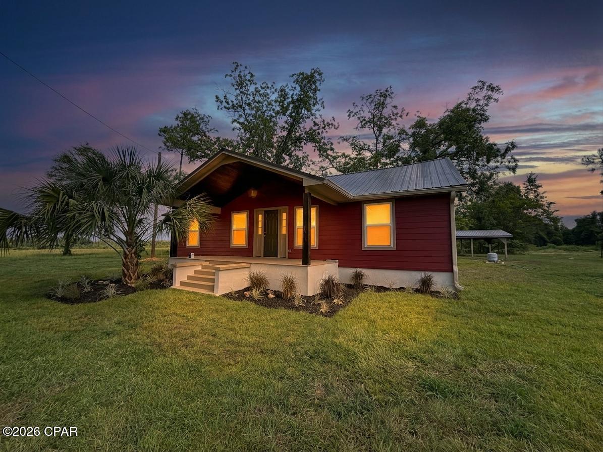 Welcome home to this beautifully completely rebuilt 3-bedroom, 2-bathroom residence by Steve Miller Construction, where timeless design meets modern convenience. Nestled on a spacious 1.06+/- acre lot, this Hardie board-clad home offers charming curb appeal with a welcoming covered front porch and a peaceful outdoor setting surrounded by mature Live Oaks.

Inside, you'll find a thoughtfully designed, move-in-ready home featuring luxury vinyl plank flooring throughout, an inviting open layout, and a stunning brand-new classic white kitchen complete with elegant quartz countertops, stainless steel appliances, and finishes that blend beautifully with any décor.

The primary suite offers a custom feature wall adding a unique designer touch, while the upgraded primary bathroom showcases a beautiful colored subway tile shower, modern fixtures, and spacious double vanities. Every detail has been carefully selected to create a home that feels both stylish and comfortable.

Enjoy quiet mornings and relaxing evenings overlooking the gorgeous Live Oaks from the open back deck. The property also includes a matching pole barn painted to complement the home, providing excellent space for storage, hobbies, equipment, or outdoor projects.

Located just a short drive from Marianna K-8th School, this home offers added convenience for families with school-aged children while still providing the privacy and space of an acreage property.

This home has been rebuilt with peace of mind in mind, featuring a new roof, new electrical system, new insulation, new windows, and a new electric tankless water heater. With quality craftsmanship, modern upgrades, and a beautiful setting, this property offers the rare opportunity to enjoy a like-new home with the charm and character of an established homesite.