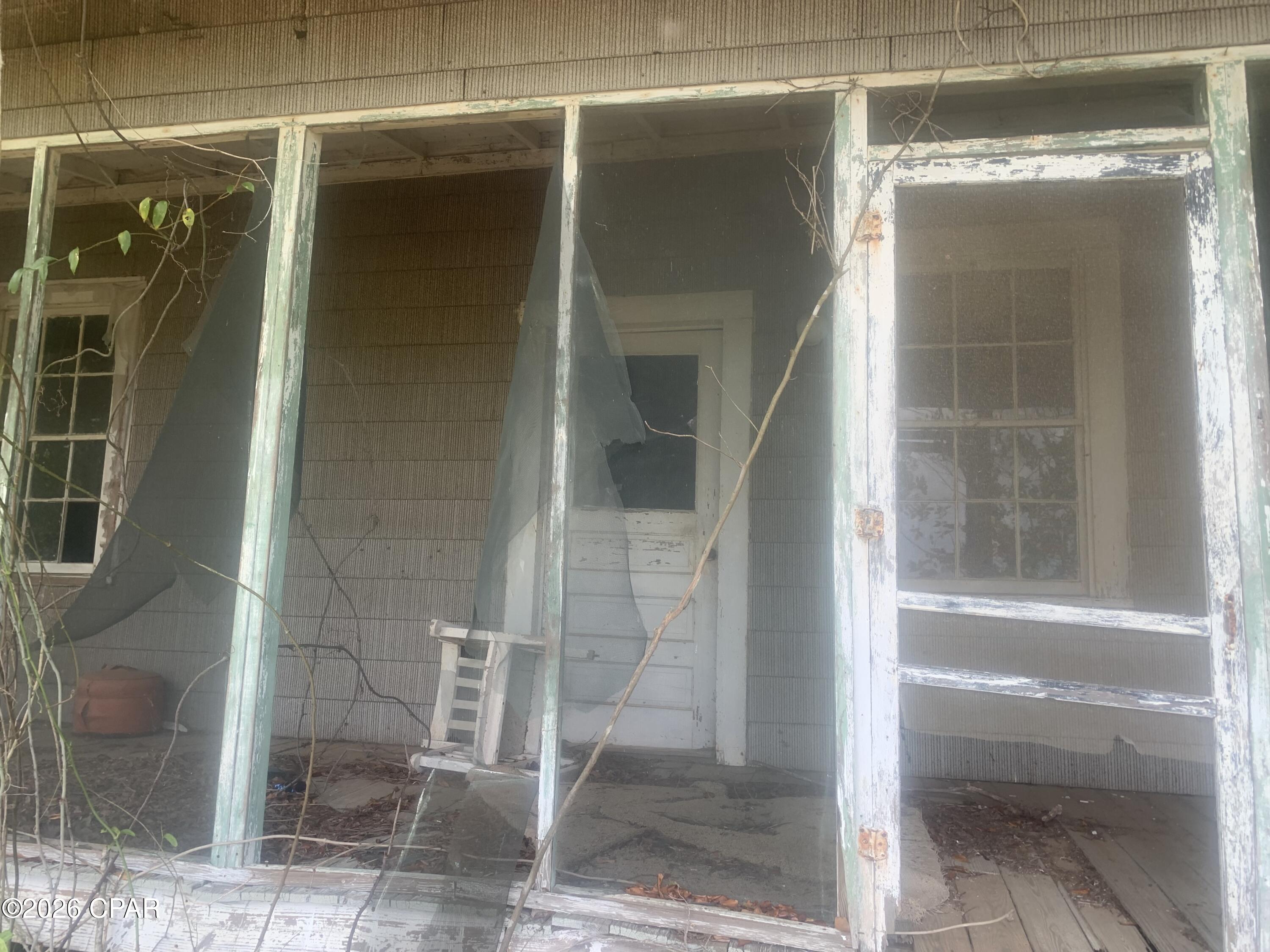 This home is the ultimate fixer upper. It is huge. It was a magnificent large stately home  in past years. It has been about 20 years since anyone lived in it.  It was built about 100 years ago. The property appraiser put down 1900 as the built date, which is most likely incorrect. The room measurements are approximations. The home has 12-foot-high ceilings in most of it. It has a metal roof. The metal roof has held up well and the home has very few leaks. The wood that was used to build this home no-doubt came mostly from virgin heart pine timber, which is not prone to termite damage or other WDO. The home was (had to have been) treated for termites (obviously as the home is fairly solid throughout). In its day, it was one fine stately home! I had a pest control company come assess the termite or WDO damage to see if it was restorable. They said it is! It does have some WDO damage to one or two support beams is what they reported. It is off grade with a crawl space. Overall, the home is restorable. One of the add on rooms that was added on years after the original construction does have more WDO damage (as obviously it was not built with the virgin heart pine which comprises 95% of this home. It has a large front porch along the front of the home. The front porch deck boards are in sad shape, but one you come into the main house it is a solid home. The lot is to be surveyed (buyers' expense) out of the 39-acre farm field. It will be an acre deep (209 ft) and have 260 ft on the paved road. This is not a quick fix fixer upper, however, due to the large square footage and high ceilings and true CHARACTER of a fine-fine older home there is plenty of upside $$$ on a fixer upper flip. OR: no doubt it will make a super fine large home for some family once the renovations are complete! One consideration for the renovation would be to turn it into a duplex because there is plenty of inside square footage to do so.