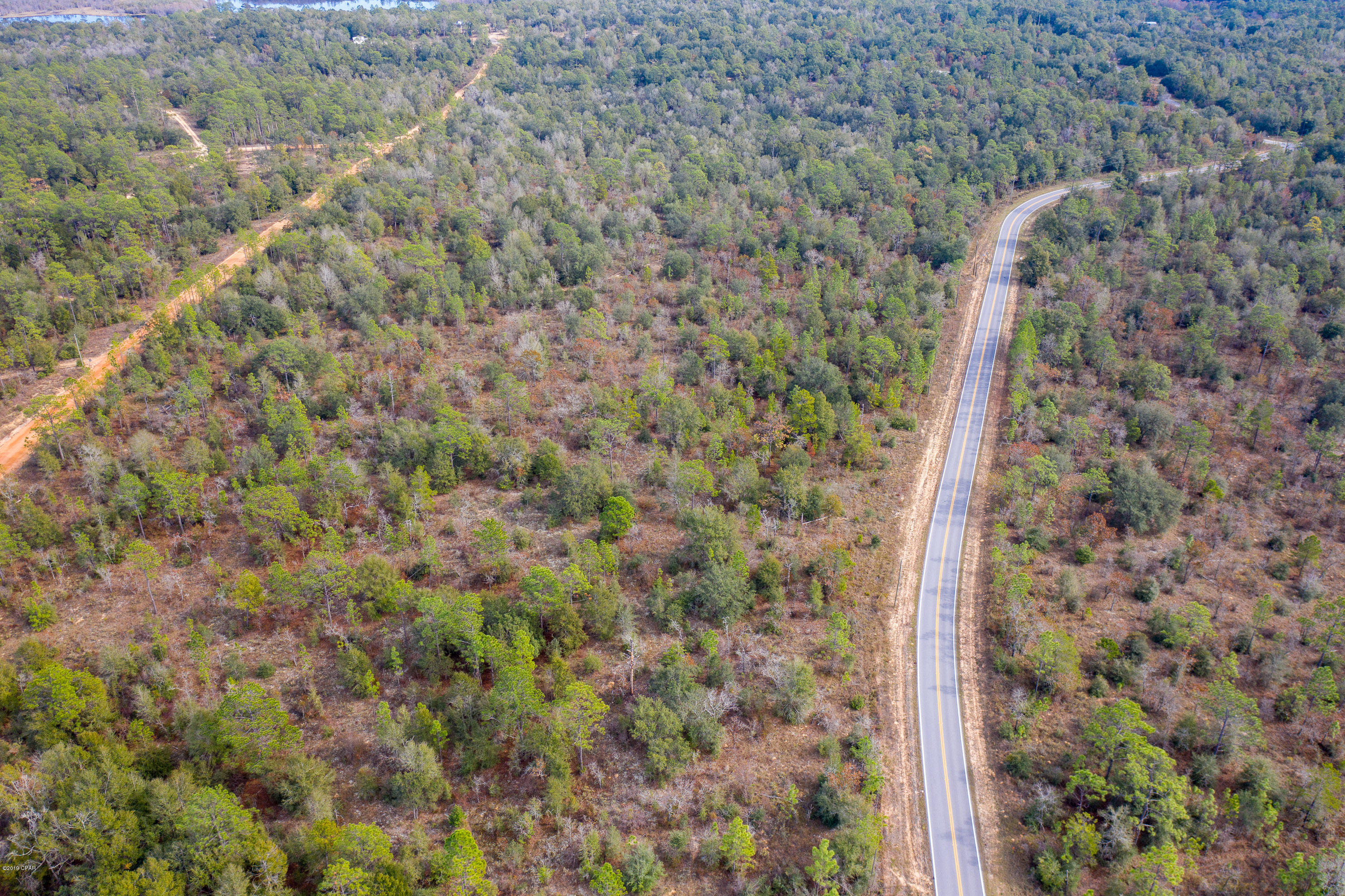 Little bit of Country with this wooded parcel.  Just right for your home. Lucas Lake is only a hop n skip for your fishing and boating pleasure not to mention an easy drive to town, schools and beaches. No restrictions and owner financing available with 20% down. Come take a peek, we won't mind.
