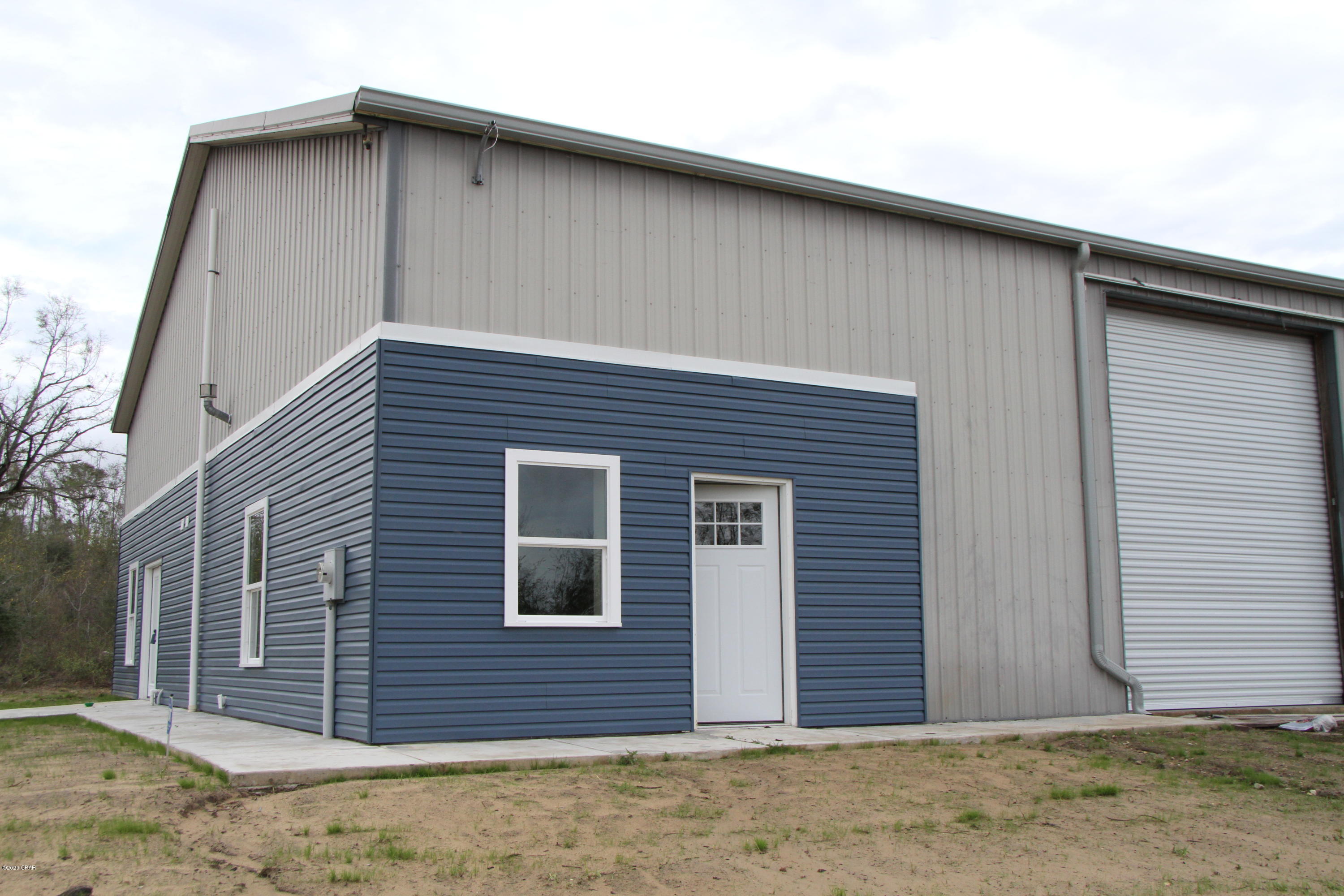 Such a rare and unique property on 15 plus acres. Completely remodeled living space integrated into a warehouse or workshop  building that lets you get creative on its use. If you have been looking for live work create space - this is the place! The warehouse/workshop which is an over 3200 SF  area consists of two 14 foot high rollup doors, a half bathroom, and a 17x51 foot storage space over the living space.  The living quarters consists of 1 amply sized bedroom plus closet storage, a fabulously updated bathroom, an open kitchen/dining combo and a living room that could double as an office.  Brand new Windows, Flooring, A/C, updated bathroom, kitchen and new appliances.