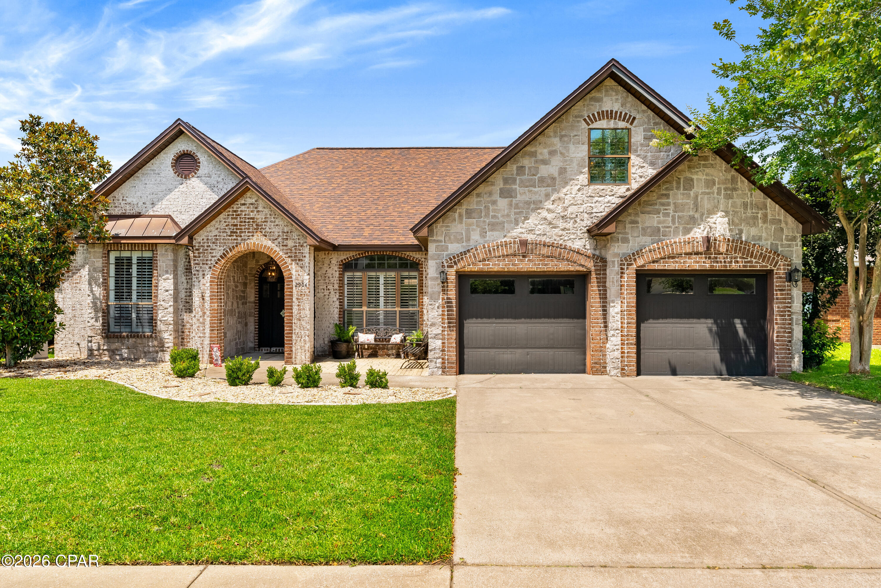 VA financing opportunity: An existing 5.25% VA loan may be assumable by a qualified buyer with VA entitlement, including an eligible veteran or military-connected buyer, subject to lender/VA approval and verification of terms. An excellent opportunity for a qualified buyer looking for a lower-than-prevailing rate and corresponding payment.

Set in desirable Hawks Landing, 2904 N Hawks Landing Blvd pairs timeless brick-and-stone architecture with a polished private-pool lifestyle in one of Panama City's most convenient neighborhoods. Inside, warm hand-scraped-style plank flooring flows through the main living areas and kitchen, complementing crown molding, plantation shutters, arched openings, custom built-ins, and a dramatic stacked-stone fireplace. The kitchen offers granite countertops, richly stained cabinetry, stainless appliances, a gas cooktop, double ovens, breakfast bar seating, and a bright dining nook. The main-level primary suite includes two closets and a well-appointed bath with dual vanities, jetted tub, and separate tiled shower, while the upstairs suite/flex room is ideal for a 4th bedroom, office, media space, or guest retreat. Outdoors, a covered patio opens to a refined backyard escape with newly updated paver lounging and dining areas, pergola, manicured lawn, privacy fencing, and a sparkling in-ground saltwater pool.

Hawks Landing offers a cohesive streetscape of custom-style homes, sidewalks for neighborhood strolls, and a central location convenient to shopping and dining, medical offices, Lynn Haven, Downtown Panama City, St. Andrews, Panama City Beach, Tyndall AFB, and NSA Panama City. The neighborhood is adjacent to Bay Haven Charter Academy's Hawks Landing Blvd campus and less than a 1/2 mile from A. Crawford Mosley High School.

Buyer to verify school zones, charter admissions/eligibility, and all information. Measurements are approximate. Reach out to schedule your private showing before this custom home is spoken for.