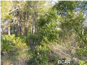 Large building lot in fast growing area, located on Half Acre Lane. Close to the Beaches, Pier Park, Frank Brown Park, Dining and Entertainment. Approximately 20 minutes to new International Airport site, City sewer in front of the property. Great Location! Seller is a licensed real estate agent in the state of Indiana.