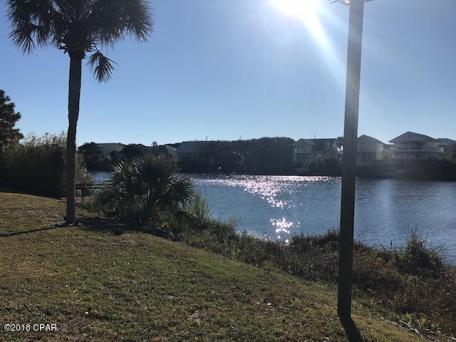 Beautiful wooded large Lakefront Lot on the highly demand west end of Panama City Beach.Only a short walk to Beach Access # 86. Make it yours for that beach dream house soon before someone else does.