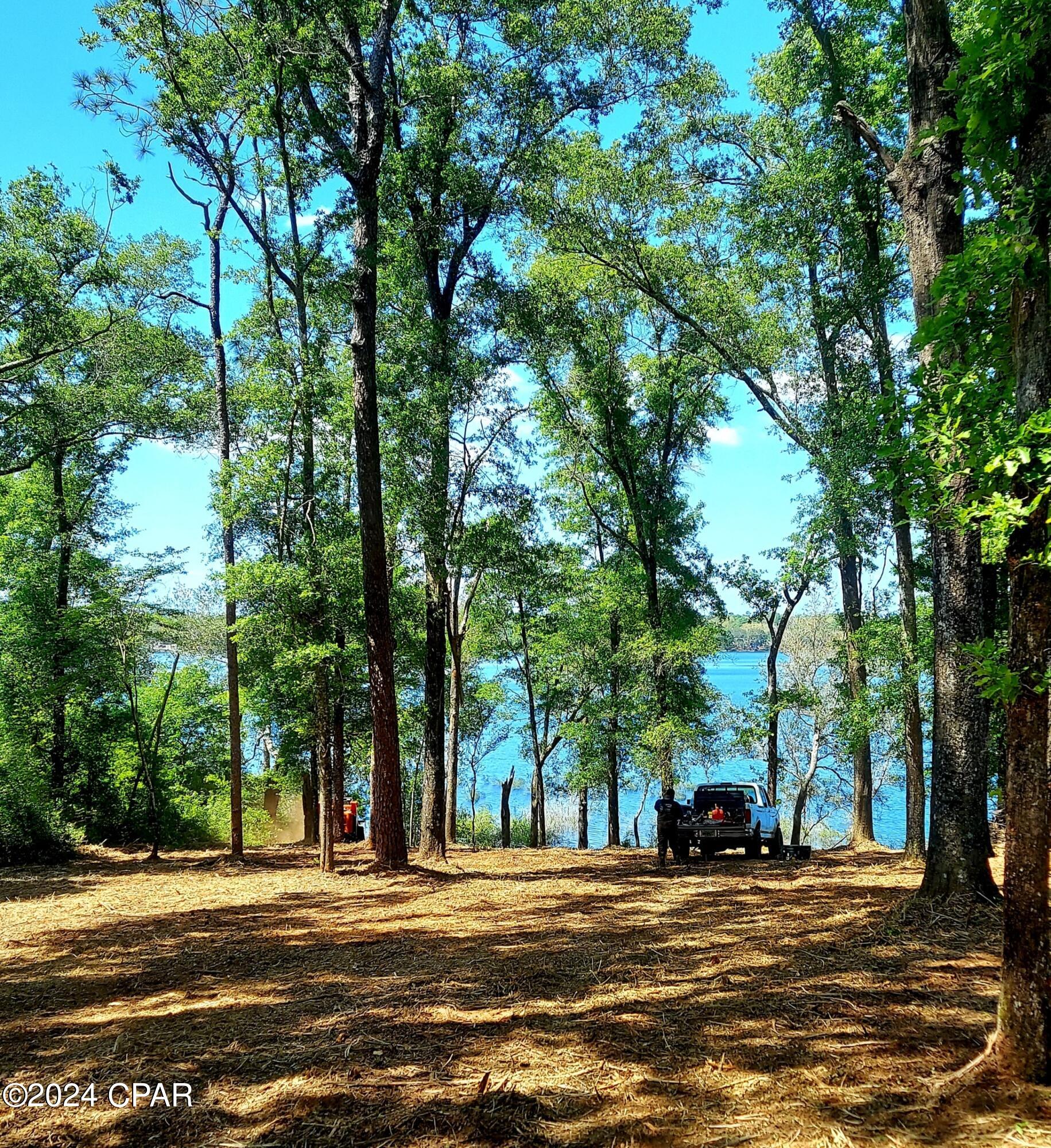 CURRENTLY UNDER CONTRACT, SELLER WILL CONSIDER BACKUP OFFERS' Welcome to the hidden gem of Northwest Florida, just a short drive from Panama City and the World's Most Beautiful Beaches. This security gated subdivision is a wonderful place to live or enjoy on weekends. The clear lake is about 1 mile across, or about 3 miles around which makes for some fun exploring. The clear water is great for swimming, kayaking, fishing, or just gazing at the beauty from your future back deck. Build the home of your dreams and enjoy a much slower pace of life. Amenities at the recreation are include a basketball court, tennis court, swimming pool, toddler playground, concrete boat launch, grill stations, full rental kitchen for parties, picnic tables, fishing and more. Come see what you are missing!