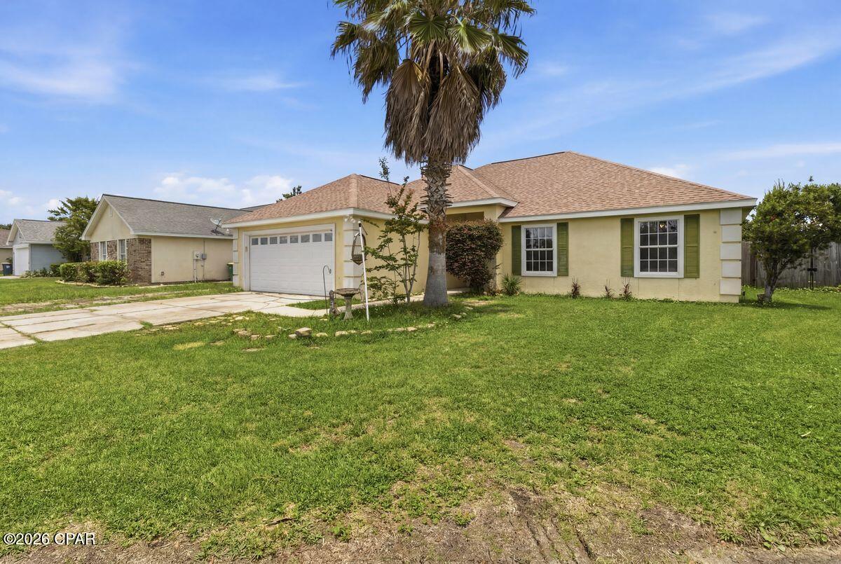 Life here revolves around sunny afternoons by the pool, evening golf cart rides through the neighborhood and easy access to the beach whenever the mood strikes. Located on a quiet cul-de-sac in Hidden Pines, this thoughtfully maintained home offers 1,710 square feet of comfortable living space and a versatile layout adaptable to a variety of lifestyles. Currently configured as a two-bedroom, two-bath residence, the home was originally built as a three-bedroom and could easily be returned to its original floor plan. Inside, soaring ceilings create an airy sense of space throughout the home. A screened porch extends the living space outdoors, providing a comfortable spot to enjoy morning coffee or unwind after a day on the water. Beyond, a private swimming pool creates a backyard retreat perfect for cooling off on warm afternoons, hosting friends and family or simply enjoying the Florida sunshine. Whether you're searching for a primary residence, a second home near the coast or an investment opportunity, this property offers exceptional versatility. With short-term rentals permitted and a desirable location just minutes from beaches, marinas, shopping, dining , entertainment, and a walking path to Patronis Elementary, it presents a rare opportunity to enjoy both lifestyle and income potential in one appealing package.