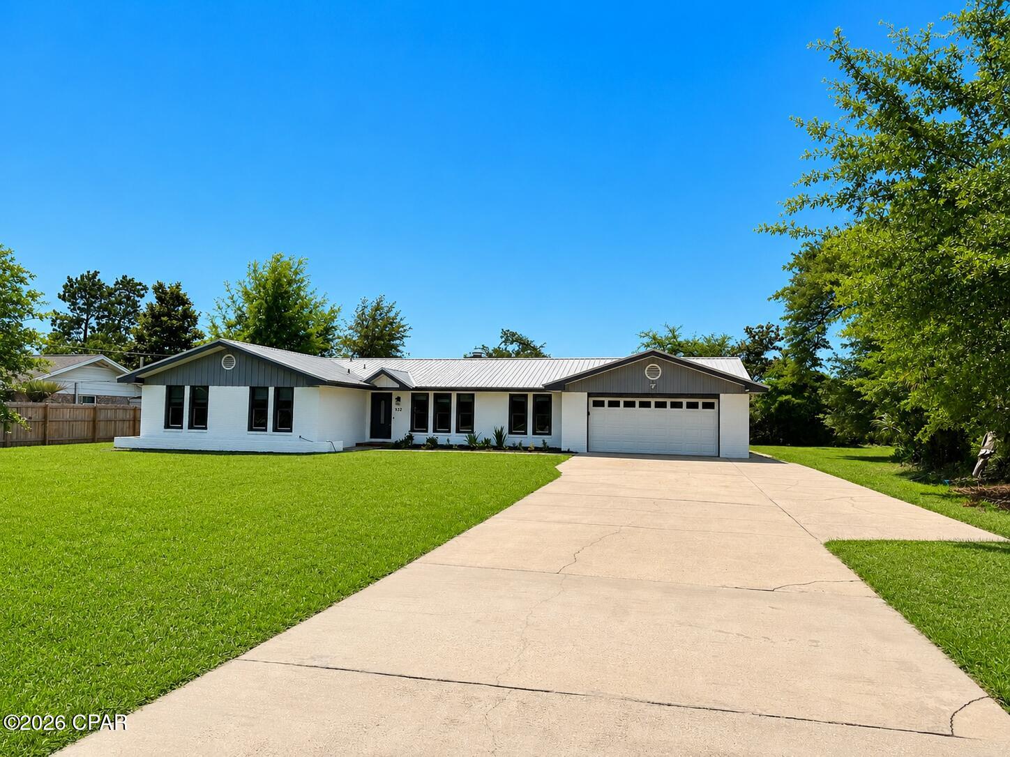 OPEN HOUSE SUNDAY MAY 31ST FROM 1-4.  Beautifully remodeled all-brick rancher situated on a spacious .56-acre lot in the highly desirable College Point area of Lynn Haven. This move-in ready home has been extensively upgraded throughout and features a freshly repainted exterior and durable metal roof. The custom chef's kitchen is truly the heart of the home, offering granite countertops, stainless steel appliances, built-in desk space, and abundant cabinetry. The kitchen opens seamlessly to the large family room featuring a stunning brick wood-burning fireplace and vaulted beamed ceilings, creating the perfect space for entertaining and everyday living.

The home also offers a formal living room, beautifully remodeled bathrooms, 20-inch tile flooring throughout main living areas, hardwood floors, and new carpet in two bedrooms. The attached two-car garage features a new epoxy floor coating for a clean, finished look.

Enjoy outdoor living year-round on the oversized screened rear patio overlooking the expansive backyard. The property also offers rear yard access and exceptional storage options with a massive 36x30 metal building with roll-up door ideal for RV or boat parking, plus an additional 30x30 metal building perfect for a workshop, hobby space, or extra storage.

Located in a golf cart-friendly neighborhood just minutes from Lynn Haven's popular parks including Lynn Haven Sports Complex, Isaac Byrd Park, Lauren Merriam Park, Lynn Haven Bayou Park & Preserve, Cain Griffin Park, Leslie Porter Wayside Park, and Sharon J. Sheffield Park. Take your golf cart down to Isaac Byrd Park and enjoy breathtaking sunsets along the bay. This property truly offers the perfect combination of comfort, functionality, and lifestyle.