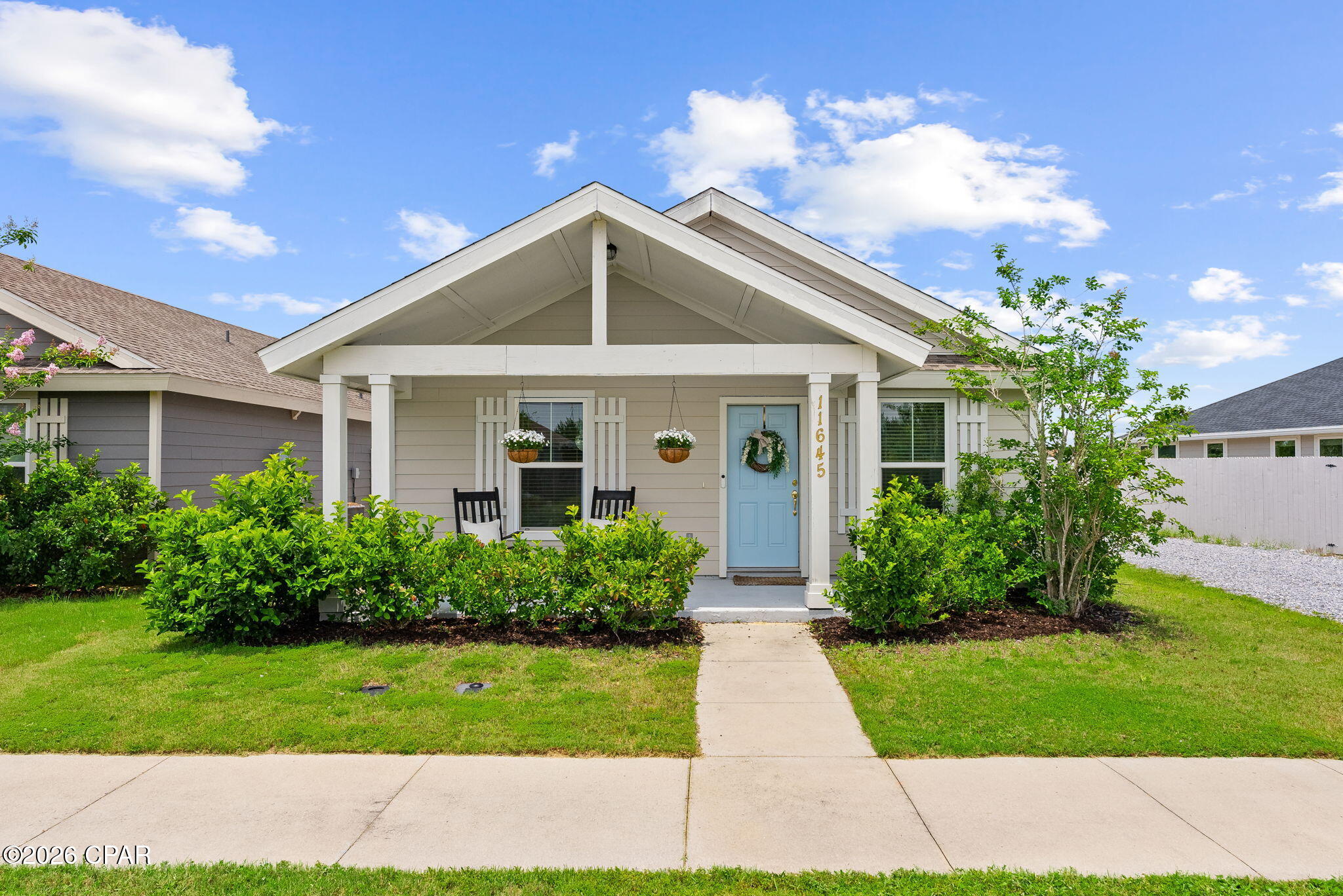 Welcome to 11645 Poston Road in the desirable Sunrise at East Bay community! This well-maintained 2-bedroom, 2-bath Craftsman-style home offers the perfect blend of comfort, convenience, and functionality. Built in 2020, the open-concept floor plan features durable luxury vinyl plank flooring, a spacious kitchen with granite countertops and stainless steel appliances, and a bright living area designed for easy everyday living. One of the standout features of this property is the detached 2-car garage accessed from the rear alley, plus an additional parking pad providing extra space for guests, work vehicles, recreational toys, or a boat. The fully fenced backyard offers privacy and room to relax, while the covered front porch creates a welcoming place to enjoy Florida evenings. Located just minutes from East Bay, public boat launches, fishing, and waterfront recreation, this home is also ideally situated for military personnel with convenient access to Tyndall Air Force Base. Whether you're looking for a primary residence, a low-maintenance coastal retreat, or an investment opportunity, this move-in-ready home checks all the boxes. Don't miss your chance to own a home that combines modern construction, extra parking flexibility, and a prime location near Tyndall AFB and all that Panama City has to offer!