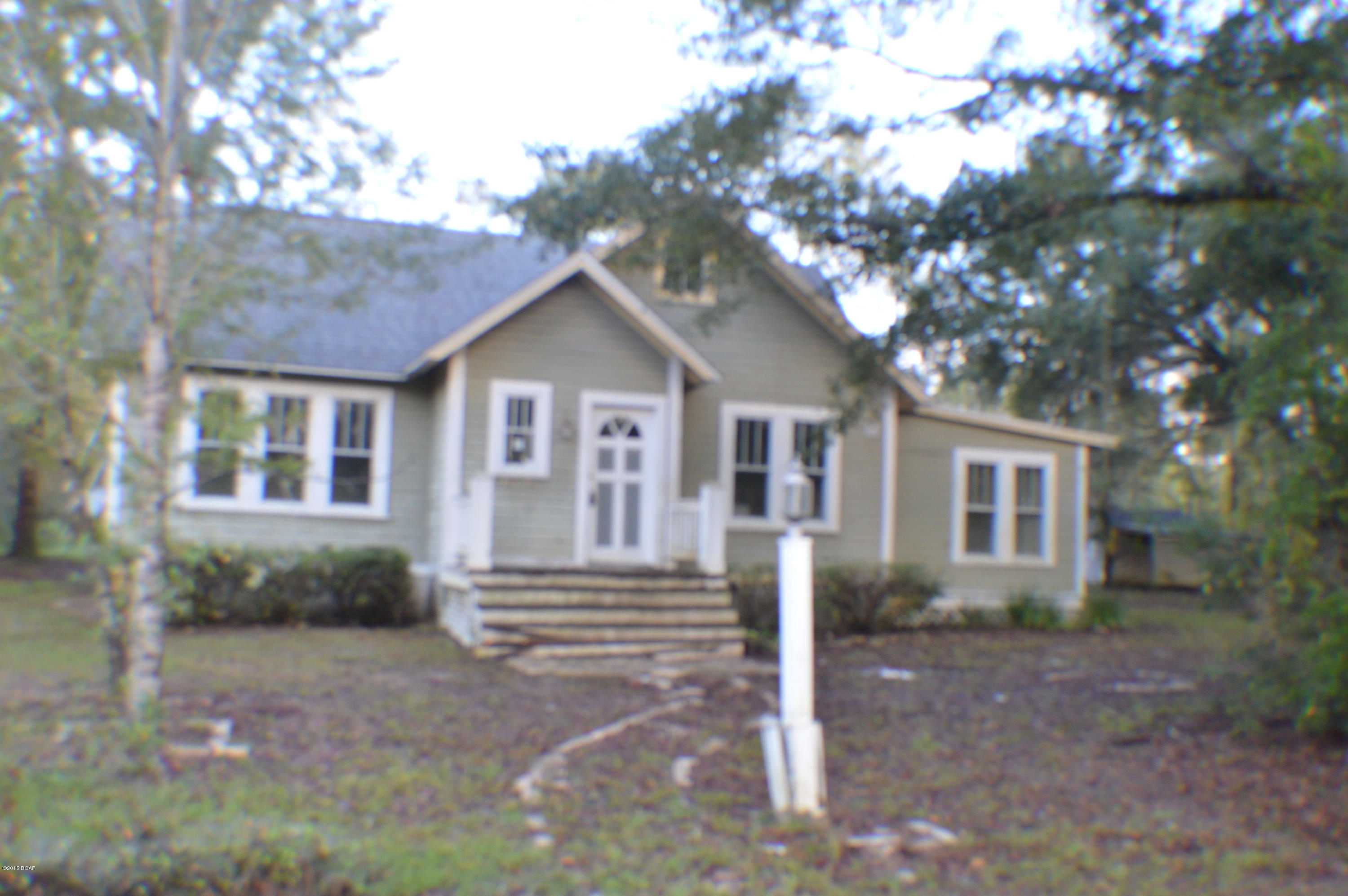 Great location.. Cute Florida style cottage with lots of potential. Home is in need of some TLC. Acreage is located on corner with frontage on 2 paved roads with enough land for a horse or 2. Land also has couple outbuildings.