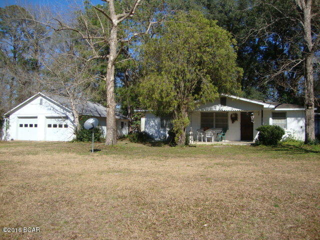 3 bedroom 1 bath block home on 3/4 of an acre with over 340 ft. frontage on paved road just minutes to Bonifay! This sturdy concrete slab block home has a nice country kitchen and a separate dining room. Home is in good shape for an older home and reminds you of grandma's house. Side door in kitchen leads out to a covered concrete deck which would be ideal for those evening cook-outs. Block storage building conveniently located behind home holds hot water heater, washer & dryer, plus has a laundry sink. The 2-car metal garage/workshop is in very good shape and on a concrete slab. It has a 1 bedroom, 1 full bath apartment in the back of the workshop that could provide rental income, be used for guests or be a great man-cave. There are no restrictions on the land, plus a large propane tank that stays. Nice garden area to the North of the workshop. A mechanic could have his own workshop right at his home. The compact apartment could provide monthly rental income. Check it out today!!!!