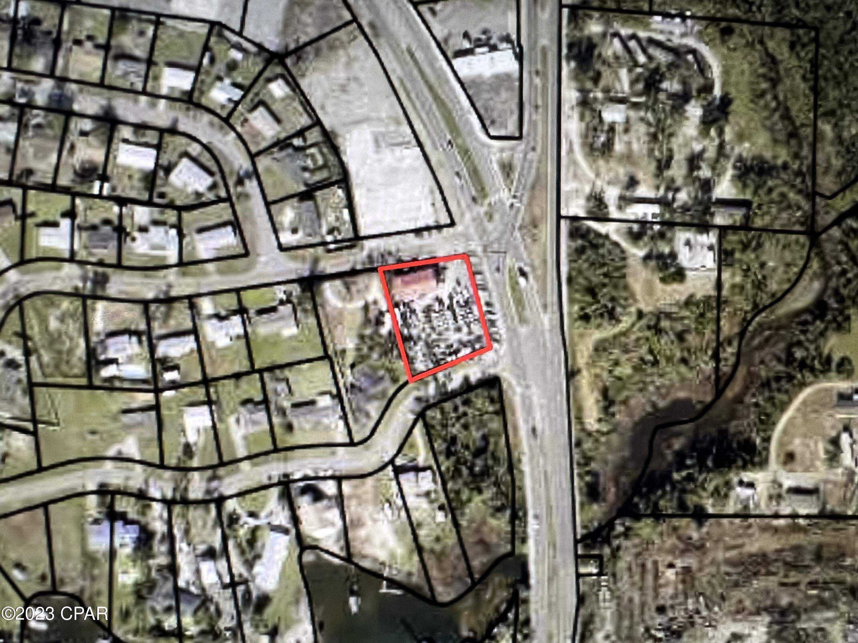 Here's a great opportunity for your business on one of the busiest intersections in the county, smack-dab in the middle of the business corridor of Parker, FL.   This general commercial lot is located on 2 principle artery roadways, with average daily traffic counts of over 19000/day on Tyndall Parkway- Hwy 98,  and 7900 per day on E.Business 98,  according to the Florida DOT;  making this parcel extremely convenient to Tyndall Air Force Base and Mexico Beach. Acquire this prime commercial location with road frontage on 3 sides, including approx 184 feet of Hwy 98 frontage!   Included in the sale is a brand new 3360 SF building with 1000 SF of heated and cooled space. This is a turn-key operation to acquire an established, thriving  Auto sales location.  No other auto shops licenses will be granted on this main artery to Tyndall and Mexico Beach. Or, this commercial location can accommodate whatever you're needing with development standards of:  Maximum building height is 60 feet/6 stories,  10 ft setbacks on 3 sides, and maximum lot coverage of 90% allowable.  This quaint, small area of Florida is growing with visitors due to the bays, bayous, new developments and new city fishing pier and boat launch, all within a few blocks of this parcel.  . (Some, not all inventory shall convey.  Lifts and permanent structures to convey.  Buyer to verify any and all information that is important.)