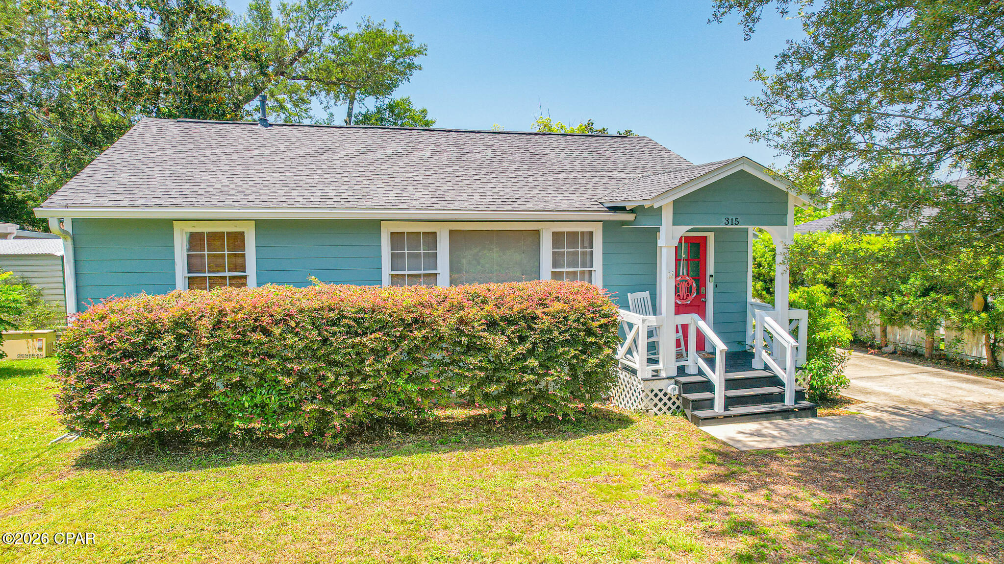 Welcome to 315 Allen Avenue, a beautifully renovated Cove bungalow where timeless character, thoughtful modern updates, and the relaxed charm of coastal Panama City come together perfectly.

Tucked beneath moss-draped oaks in a quiet corner near Massalina Bayou, this Craftsman-inspired home welcomes you with the unmistakable warmth of The Cove lifestyle. Just one block from the bayou and minutes from Historic Downtown Panama City, the location offers the perfect blend of peaceful neighborhood living and convenient access to waterfront walks, dining, shopping, and entertainment.

Inside, you will be pleasantly surprised by the spacious, open layout. Oversized windows fill the home with natural light and beautifully showcase the original hardwood floors. The generous living and dining areas provide plenty of flexibility for comfortable everyday living, entertaining guests, or creating multiple conversation and seating spaces.

A cozy room just off the main living area is ideal for a breakfast nook, home office, reading room, or coffee bar. The kitchen offers a delightful blend of vintage character and modern style, featuring elegant marble countertops, stainless steel appliances, a gas range, warm wood flooring, glass-front cabinetry, and plenty of space for preparing meals and gathering with family and friends.

A versatile bonus room overlooking the tree-shaded backyard provides even more flexibility. With its own private entrance, this space could serve beautifully as a third bedroom, den, sunroom, home office, playroom, or guest retreat.

The hardwood flooring continues into the spacious primary bedroom, which comfortably accommodates a king-size bed. The updated primary bathroom includes a  shower with glass doors, private dressing area, and a large second closet with built in drawers creating a comfortable and functional retreat. A guest bedroom and renovated hall bathroom are conveniently located just off the main living areas.

The home has been extensively updated over the years, including electrical, A/C system, plumbing, windows, roofing improvements, interior and exterior paint, and a rear sliding glass door, allowing you to enjoy the beauty and character of an older home with added comfort and peace of mind.

Just steps from the home, the oversized detached garage and workshop offers exceptional storage and workspace. With both water and electricity already available, the building presents endless possibilities for hobbies, projects, a studio, home gym, or future guest space. The landscaped yard also features a well and irrigation system, making it easier to maintain the beautiful outdoor surroundings.

The Cove is beloved for its tree-lined streets, bay views, golf-cart-friendly atmosphere, and strong sense of community. Take an evening stroll along the Cherry Street improvements, gather with neighbors to watch the sunset at the bayside railing, launch your boat or kayaks(2 included with the home!) at the marina, or head downtown to enjoy locally owned restaurants, boutique shopping, community events, and entertainment.

Filled with warmth, character, and modern convenience, 315 Allen Avenue is more than a home, it is an opportunity to enjoy the authentic Cove lifestyle in one of Panama City's most treasured neighborhoods! Don't miss this opportunity!