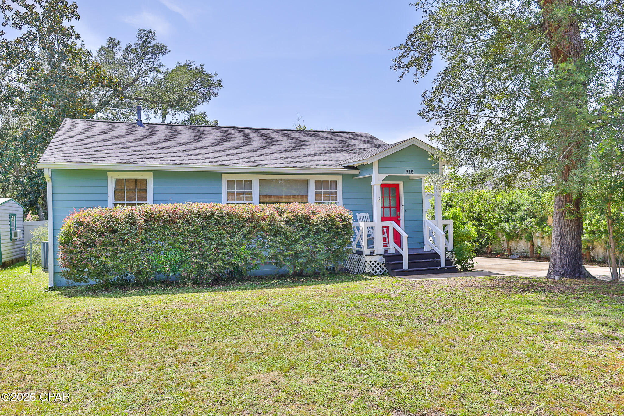 Welcome to 315 Allen Avenue, a beautifully renovated Cove bungalow where timeless character, thoughtful modern updates, and the relaxed charm of coastal Panama City come together perfectly.

Tucked beneath moss-draped oaks in a quiet corner near Massalina Bayou, this Craftsman-inspired home welcomes you with the unmistakable warmth of The Cove lifestyle. Just one block from the bayou and minutes from Historic Downtown Panama City, the location offers the perfect blend of peaceful neighborhood living and convenient access to waterfront walks, dining, shopping, and entertainment.

Inside, you will be pleasantly surprised by the spacious, open layout. Oversized windows fill the home with natural light and beautifully showcase the original hardwood floors. The generous living and dining areas provide plenty of flexibility for comfortable everyday living, entertaining guests, or creating multiple conversation and seating spaces.

A cozy room just off the main living area is ideal for a breakfast nook, home office, reading room, or coffee bar. The kitchen offers a delightful blend of vintage character and modern style, featuring elegant marble countertops, stainless steel appliances, a gas range, warm wood flooring, glass-front cabinetry, and plenty of space for preparing meals and gathering with family and friends.

A versatile bonus room overlooking the tree-shaded backyard provides even more flexibility. With its own private entrance, this space could serve beautifully as a third bedroom, den, sunroom, home office, playroom, or guest retreat.

The hardwood flooring continues into the spacious primary bedroom, which comfortably accommodates a king-size bed. The updated primary bathroom includes a  shower with glass doors, private dressing area, and a large second closet with built in drawers creating a comfortable and functional retreat. A guest bedroom and renovated hall bathroom are conveniently located just off the main living areas.

The home has been extensively updated over the years, including electrical, A/C system, plumbing, windows, roofing improvements, interior and exterior paint, and a rear sliding glass door, allowing you to enjoy the beauty and character of an older home with added comfort and peace of mind.

Just steps from the home, the oversized detached garage and workshop offers exceptional storage and workspace. With both water and electricity already available, the building presents endless possibilities for hobbies, projects, a studio, home gym, or future guest space. The landscaped yard also features a well and irrigation system, making it easier to maintain the beautiful outdoor surroundings.

The Cove is beloved for its tree-lined streets, bay views, golf-cart-friendly atmosphere, and strong sense of community. Take an evening stroll along the Cherry Street improvements, gather with neighbors to watch the sunset at the bayside railing, launch your boat or kayaks(2 included with the home!) at the marina, or head downtown to enjoy locally owned restaurants, boutique shopping, community events, and entertainment.

Filled with warmth, character, and modern convenience, 315 Allen Avenue is more than a home, it is an opportunity to enjoy the authentic Cove lifestyle in one of Panama City's most treasured neighborhoods! Don't miss this opportunity!