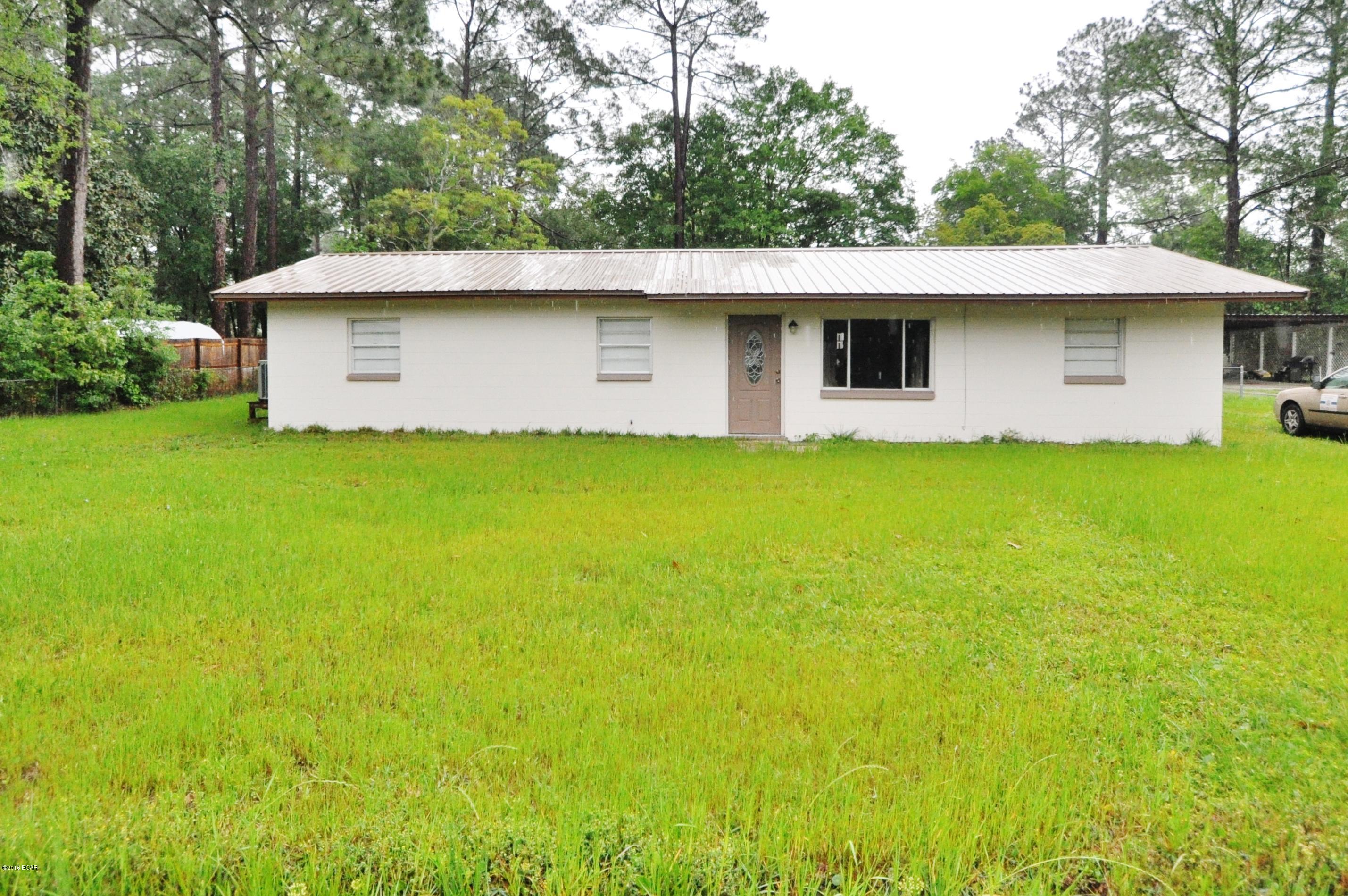 What a find in the heart of Lynn Haven this spacious 3 bedroom Home with Modern Kitchen Huge living room that has ceramic tile flooring..Nice Den Large 12x22 Covered and framed Porch that could be easily screened in.. Large 24x24 workshop in the back yard PLUS another 8x10 storage building...Roof and AC are only 2 years old..All this for UNDER $100,000 and in sought after Lynn Haven.. This property is not in a flood zone and does not require flood insurance. You can get USDA 100% financing on this place if you qualify....Call NOW before its gone for your private viewing.