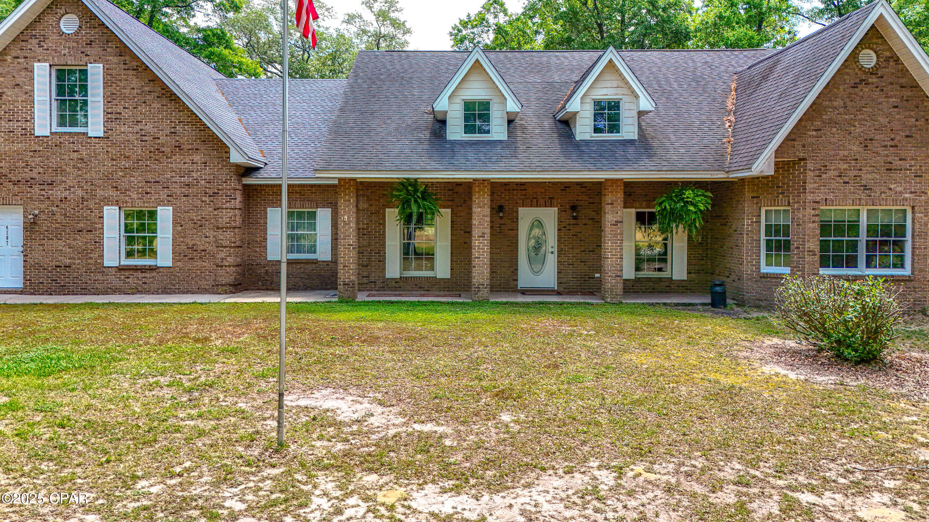 Additional acreage available!  Located just 40 minutes north of Panama City Beach and nestled between Holmes Creek and the Choctawhatchee River, this stunning brick home combines the serenity of country living with all the luxuries of modern amenities. You can launch your boat at the nearby public boat launch for great fishing or swimming in the nearby springs.
Boasting 4 spacious bedrooms and 3.5 bathrooms, this home is designed for comfort and convenience. The large kitchen features a double oven and an oversized refrigerator, ideal for preparing meals for family and friends. The open-concept layout allows the beautiful stone fireplace to become the focal point of the main living area, creating a cozy and inviting atmosphere.

The master suite and two additional bedrooms are conveniently located on the main floor. Upstairs, you'll find a finished room above the garage, adding an additional 1,000 square feet of space that can be used as a bedroom, playroom, or office, complete with its own bathroom.

Step outside onto the screened-in back porch, the perfect spot for peaceful relaxation or entertaining guests. Plus, with a full-house generator, you can rest easy knowing you'll have power during unexpected outages.

Enjoy the best of both worlds--country tranquility with easy access to the conveniences of Panama City Beach.