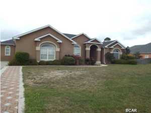 Custom built four bedroom four bathroom home in an a newer deed restricted subdivision near Lynn Haven offered as is. Amenities/upgrades include Corian countertops, lots of tile and custom features in every part of this home. The house has a large open floor plan. The back has a screened patio with large in-ground pool with built-in spa. The interior features large gourmet kitchen with island that flows into large family room. Separate spacious laundry room, huge master suite with view of pool and very large master bath with his and her closets. The property does need some TLC but is priced accordingly. All measurements approximate please verify accordingly.