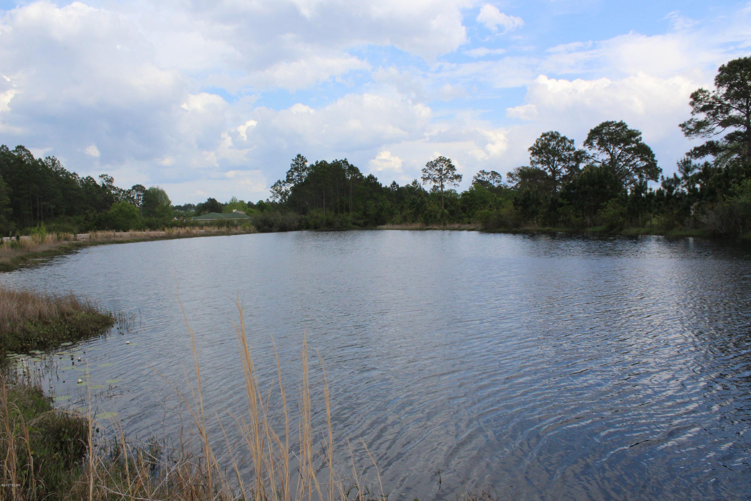 Incredible building lot. Elevated lot overlooking the small Country Club Lake. Property could be subdivided, or would make a special single family homesite. Property is cleared and city water and sewer are available. Approximately 480 feet of road frontage, and over 500 feet of waterfront.