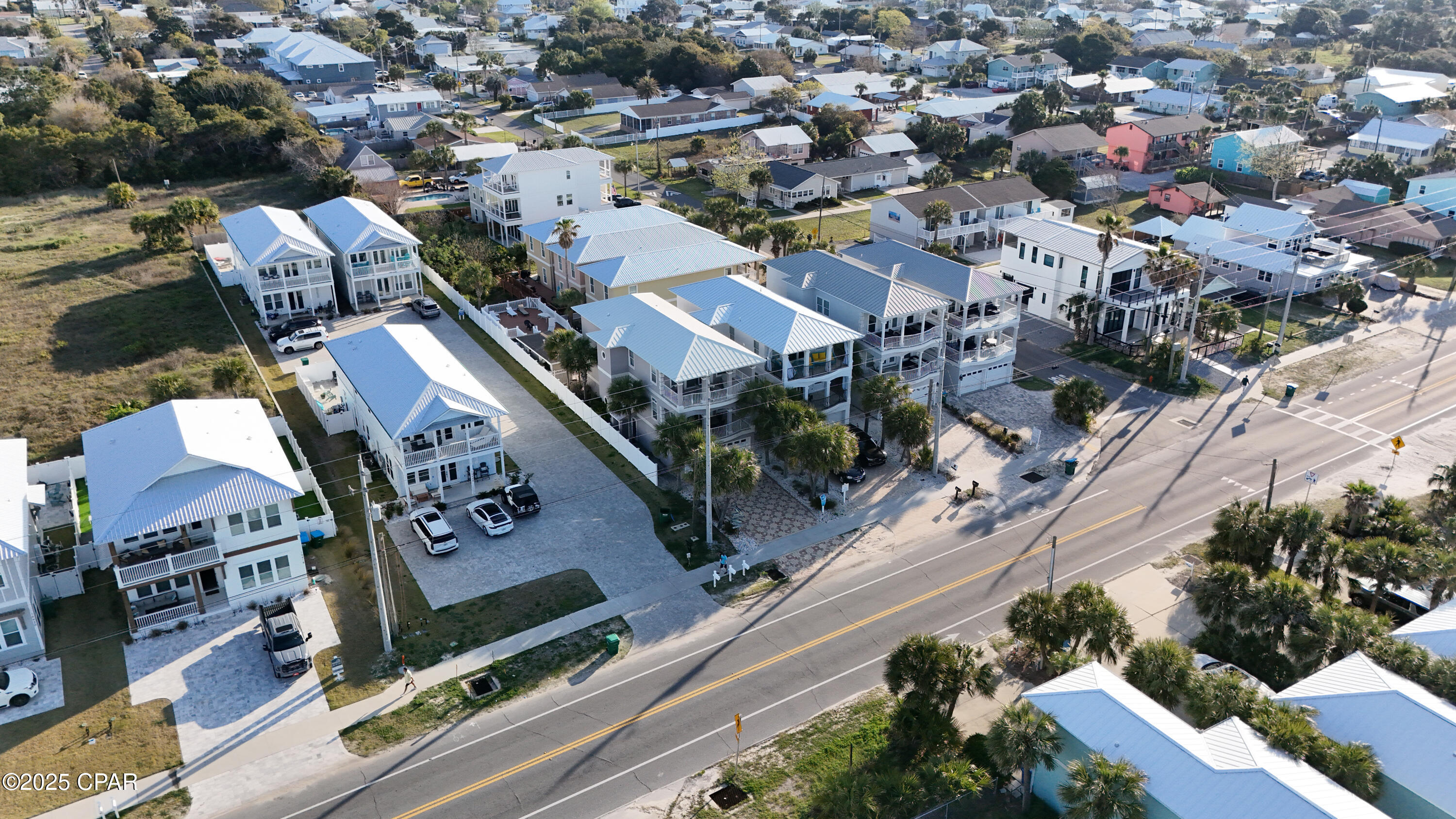 Beach house with stunning views of the gulf and beach.  This three story home features 5 bedrooms and 5 baths.  It is a rental machine generating six figure rental income.  There is a community pool behind the house.  Garage has been transformed into a game room.  There bunk room on main level to accommodate large groups.  The exterior has a fresh coat of paint.