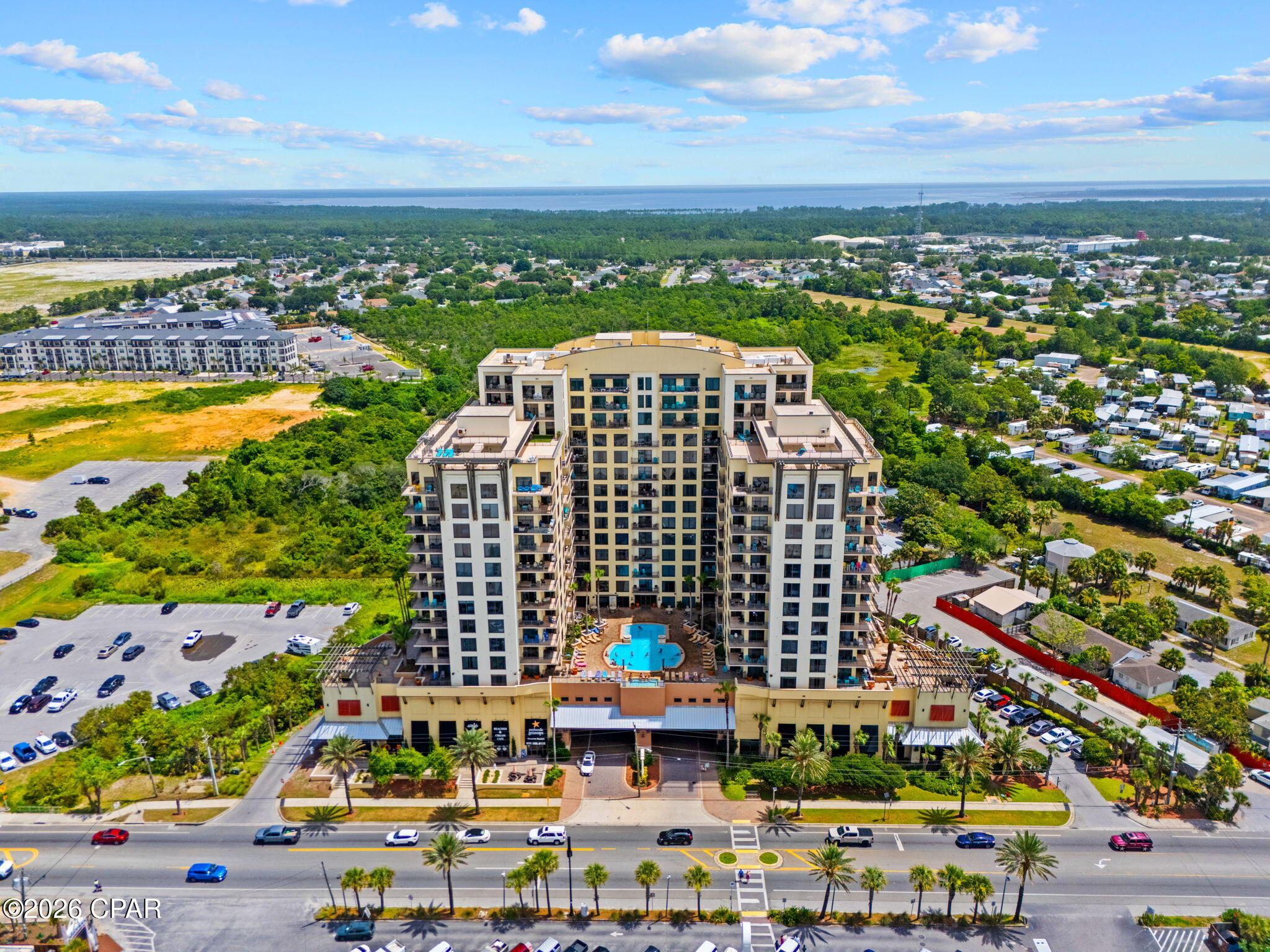 Experience luxury coastal living in this stunning Gulf-view condo featuring breathtaking views of the emerald waters from the living room, dining area, bedroom and private balcony. The main living areas are beautifully finished with tile flooring, creating a clean and elegant feel throughout the home. The custom kitchen is designed for both style and functionality, featuring custom cabinetry, granite countertops, stainless steel appliances, an under-mount sink, breakfast bar and recessed lighting. A convenient laundry area with a stackable washer and dryer and custom closet in the entry adds to the home's thoughtful design. A half bath is located just off the kitchen for guests' convenience with an updated vanity. The spacious bedroom offers a custom large walk-in closet. The luxurious en suite bathroom features a tiled shower and updated vanity, creating a relaxing retreat. Enjoy morning coffee or evening sunsets while taking in the incredible Gulf views from the balcony overlooking the Gulf and pool area. Enjoy the sunset deck on the west 15th floor and sunrise deck on the east 15th floor. Located just one mile east of Pier Park, with Sharky's directly across the street, this condo puts you close to the best of Panama City Beach -- including Top Golf, Dolly Parton's Pirate's Voyage, world-class dining, shopping, entertainment, and Frank Brown Park. Whether you're searching for a vacation getaway, investment property, or your own piece of paradise, this Gulf-front lifestyle opportunity offers the perfect blend of comfort, convenience, and coastal luxury.