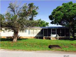 Imagine having all your beach gear together and being able to walk to the soft white sands of the gulf. You can literally see the gulf from your front yard. This double wide mobile home features two large screened porches, an outside shower, a large storage building(2011), and a sprinkler system operated by your own well water. Central AC unit installed in 2010. New metal roof(2013). All measurements are approximate and should be verified by the buyer if important.