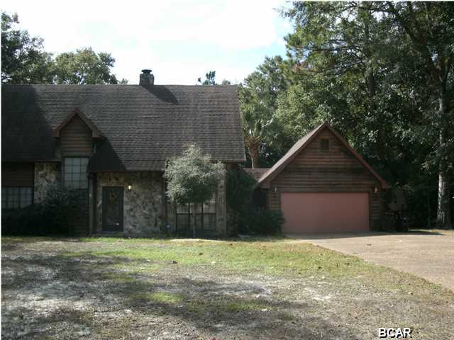 ALL SIZES APPROX: BEAUTIFUL CONTEMPORARY STONE AND SIDING CUSTOM BUILT HOME CLOSE TO TYNDALL. MANY STONE ACCENTS INCLUDING CORNER FIREPLACE. BUILT FOR AN ACTIVE FAMILY. IN-GROUND POOL SURROUNDED BY LARGE CONCRETE PATIO AND 6 FOOT PRIVACY FENCE. ENTIRE BACKYARD FENCED IN CHAIN LINK INCLUDING A SEPARATE DOG RUN. LARGE 12X20 STORAGE/WORKSHOP WITH ATTACHED 12X20 CARPORT, PERFECT FOR THE BOAT! UPSTAIRS ARE TWO BEDROOMS, FULL JACK AND JILL BATH AND A LARGE OPEN LOFT. GENEROUS MASTER BED AND BATH DOWNSTAIRS NEAR THE LIVING AREAS. LAUNDRY ROOM AND LOTS OF EXTRA STORAGE UNDER THE EAVES AND STAIRS PLUS A OVER-SIZED GARAGE AND DRIVEWAY. TRANSPARENT DETACHABLE HURRICANE SHUTTERS. 2 HVAC UNITS.