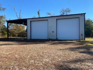 Metal Storage building and approximately 1.5 Acres for lease.  This 60 X 40 Metal building has 2 roll up doors and an open covered area.  It would make a great shop or storage for Boats or equipment.  It is very private surrounded by trees with part of the land cleared.  Electrical service to building with large commercial lighting.