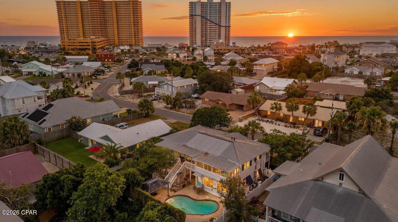 Live the coastal dream in this 3-bed, 4-bath home with 2,010 sq ft of versatile living space. The main floor features a chef's kitchen with a large island, a great room, and a sunny Florida room that opens directly to a covered deck. Outside, enjoy a private, fenced backyard paradise with a premium heated saltwater pool. Located less than a half-mile from the water, this property includes a 6-space driveway, hurricane shutters, and a tankless gas water heater. Ready for immediate occupancy!