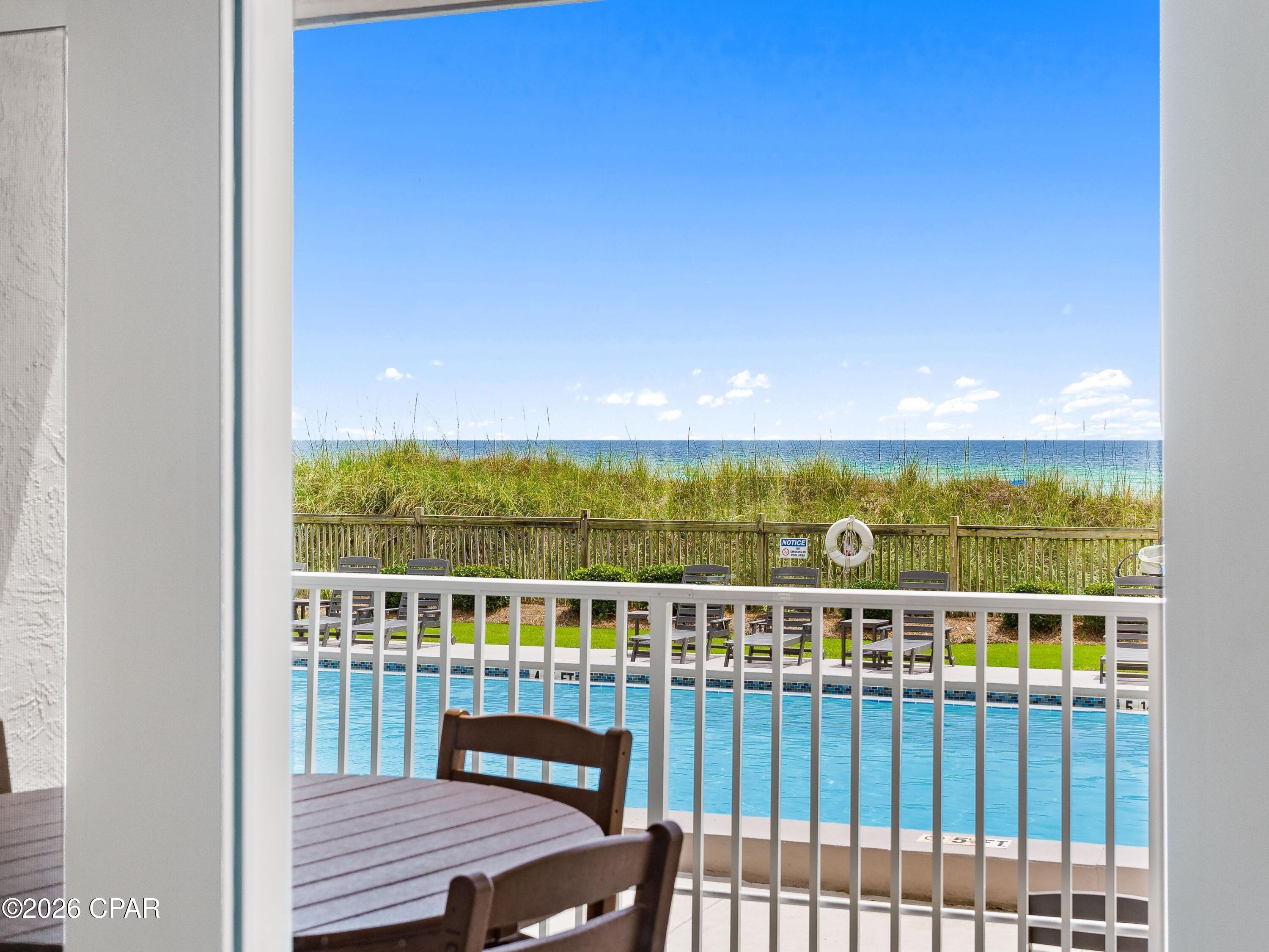 There is something to be said for a beach condo that makes life easier. Positioned on the ground floor of Mariner West, this gulf-front residence offers the rare convenience of stepping from your front door to the pool, beach and community amenities without ever waiting on an elevator. Framed by views of the gulf and the natural sand dunes beyond, it delivers the effortless coastal lifestyle buyers are searching for along the quiet eastern end of Panama City Beach.

Inside, the thoughtfully designed floor plan lives larger than expected, featuring a spacious bedroom, two full bathrooms and an open-concept living area that flows seamlessly to a covered gulf-front patio. Tile flooring throughout creates a clean, low-maintenance environment, while quartz countertops, a fully equipped kitchen and updated bathrooms add style and functionality. The generous living room offers plenty of seating for family and guests, creating a comfortable setting for everyday living or vacation stays.

This residence has also proven itself as an exceptional investment opportunity. Self-managed and not currently listed on Airbnb or VRBO, the property generated approximately $32,400 in gross revenue during 2025, with more than $21,600 already on the books for 2026. The combination of strong rental performance, direct beach access and ground-floor convenience makes it particularly appealing to both investors and second-home buyers.

Mariner West offers an impressive collection of amenities, including a beachfront pool, tennis and pickleball courts, shuffleboard, a pool table, gas grilling stations, and outdoor gathering areas overlooking the pool deck. Located along Thomas Drive, the community provides convenient access to local restaurants, shopping, marinas, golf, family attractions and some of the area's most popular waterfront destinations.

Whether you're searching for a personal beach retreat, a seasonal getaway or an income-producing investment, this gulf-front residence combines comfort, convenience and proven performance in one of Panama City Beach's most established beachfront communities.