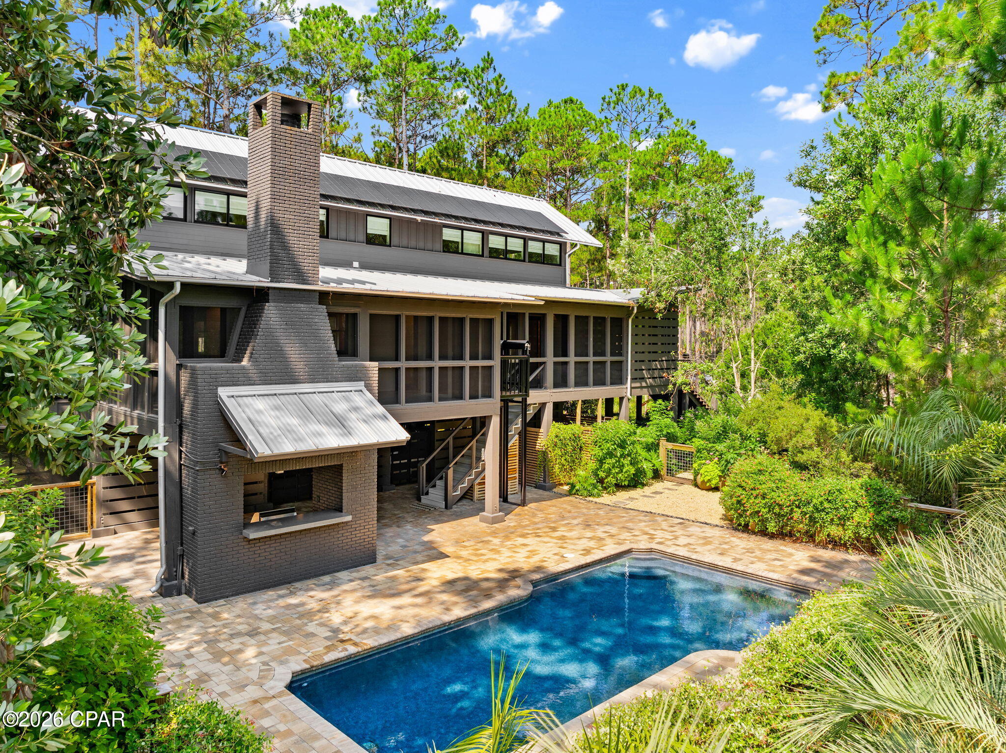 Stunning Southern Living home in the exclusive gated waterfront community of RiverCamps! Built in 2007, this beautifully updated 2,433-square-foot home offers 3 bedrooms, 3.5 bathrooms, and exceptional craftsmanship throughout. Situated on two lots totaling 1.95 acres with only one HOA fee, this rare property offers privacy, quality, and resort-style living.

Inside, you'll find hardwood floors throughout, tongue-and-groove walls and ceilings, custom built-ins, and timeless architectural details. Each of the three spacious bedrooms features a private en-suite bath, providing comfort and privacy for family and guests.

Recent updates include a new HVAC system, metal roof, appliances, water heater, washer and dryer, pool pump, solar system, and a private irrigation well. Enjoy peaceful pond views from more than 800 square feet of screened porches, a wood burning fireplace, relax by the private in-ground pool, and take advantage of the cargo lift for added convenience.
All appliances convey. Furnishings (except dining table and chairs) and new golf cart convey on acceptable offer.
Additional 2.27-acre Lot on the street is also available for $130,000 ensuring you the ultimate in privacy!

RiverCamps is a premier 1,500-acre gated waterfront community surrounded by West Bay, the Intracoastal Waterway, and Crooked Creek. With fewer than 450 homes planned, residents enjoy an unmatched blend of privacy and outdoor recreation, including a community pool, boat ramp with direct Gulf access via West Bay, day-use boat slips, more than seven miles of scenic trails and boardwalks, kayaking, boating, fishing, wildlife viewing, and golf cart-friendly streets. A new fitness center is currently under construction and is expected to be completed by the end of 2026.

Conveniently located just 10 miles from the sugar-white beaches of Panama City Beach and the shopping, dining, and entertainment at Pier Park, approximately 10 minutes from Northwest Florida Beaches International Airport, the new FSU Health hospital and medical campus, and only 2 miles from the new Publix and a planned 500,000-square-foot retail development, this home offers the perfect balance of peaceful coastal living and everyday convenience.

This is a rare opportunity to own one of RiverCamps' most distinctive homes in one of Northwest Florida's most sought-after waterfront communities. Close to everything yet far from the traffic and crowds!
